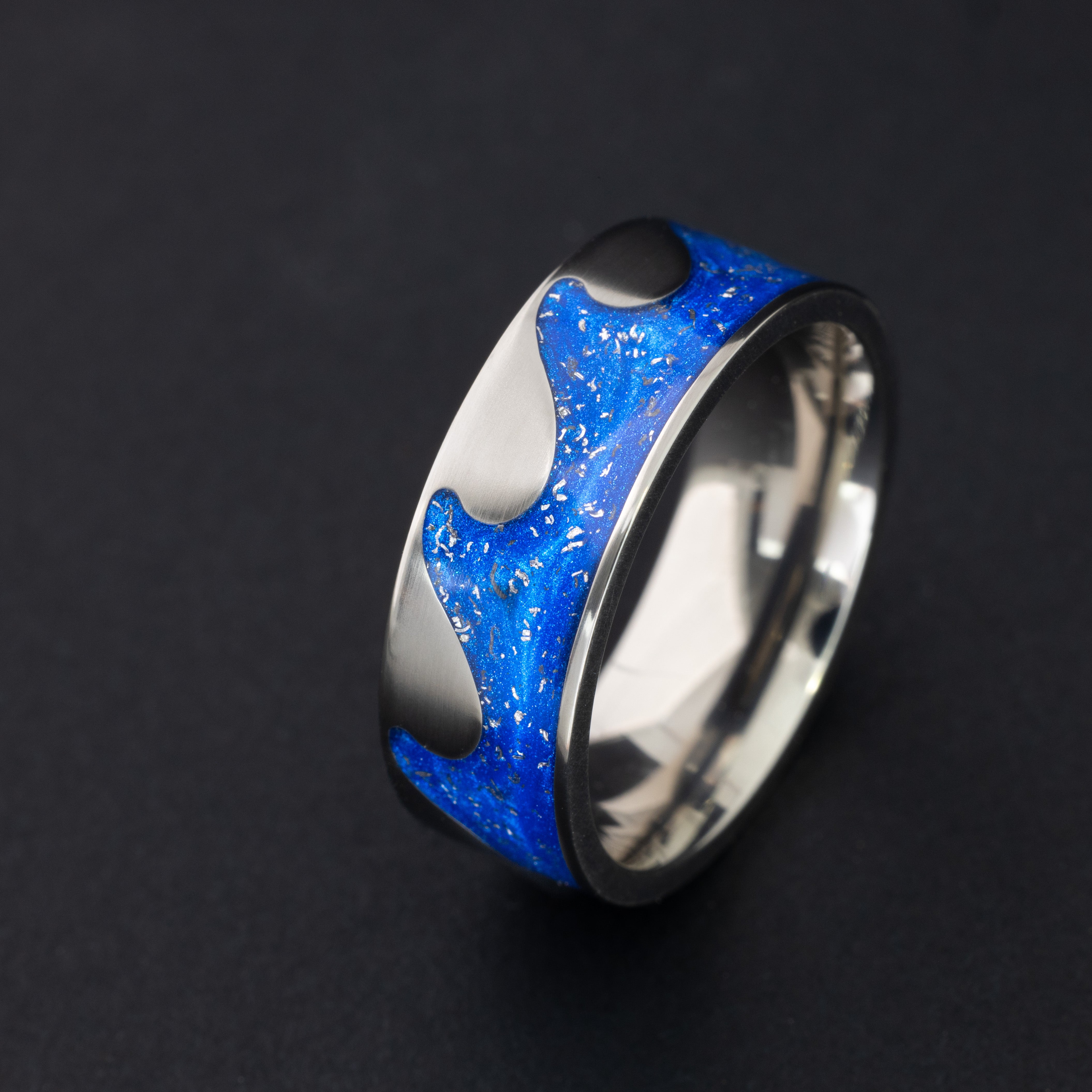 8mm titanium riptide band ring with ocean wave cutout pattern featuring authentic Campo del Cielo meteorite pieces in blue resin
