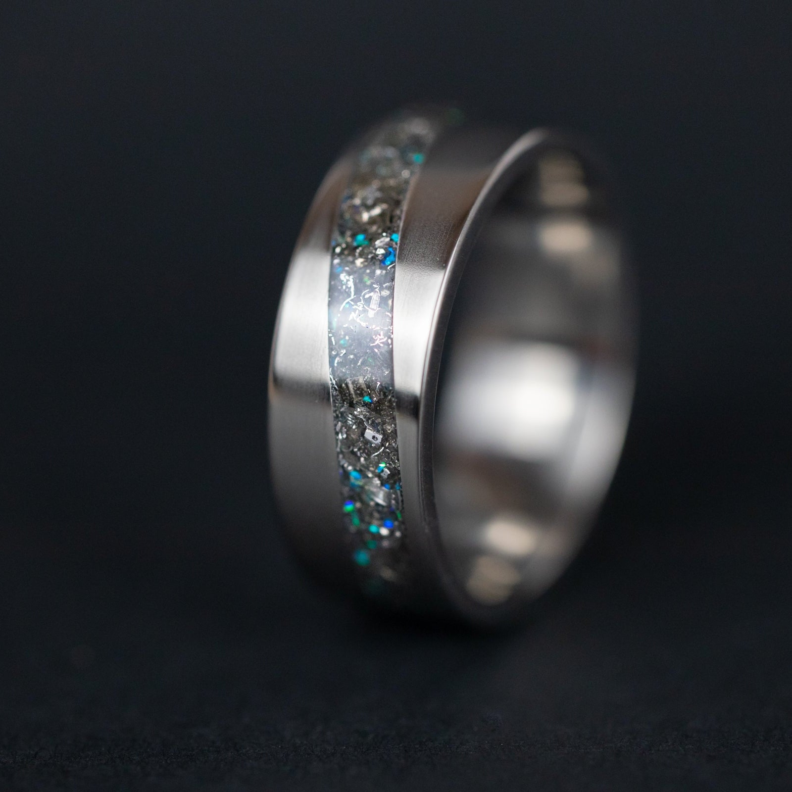 Titanium Blue Cosmic Current ring with meteorite and blue opal inlay in a curved channel.