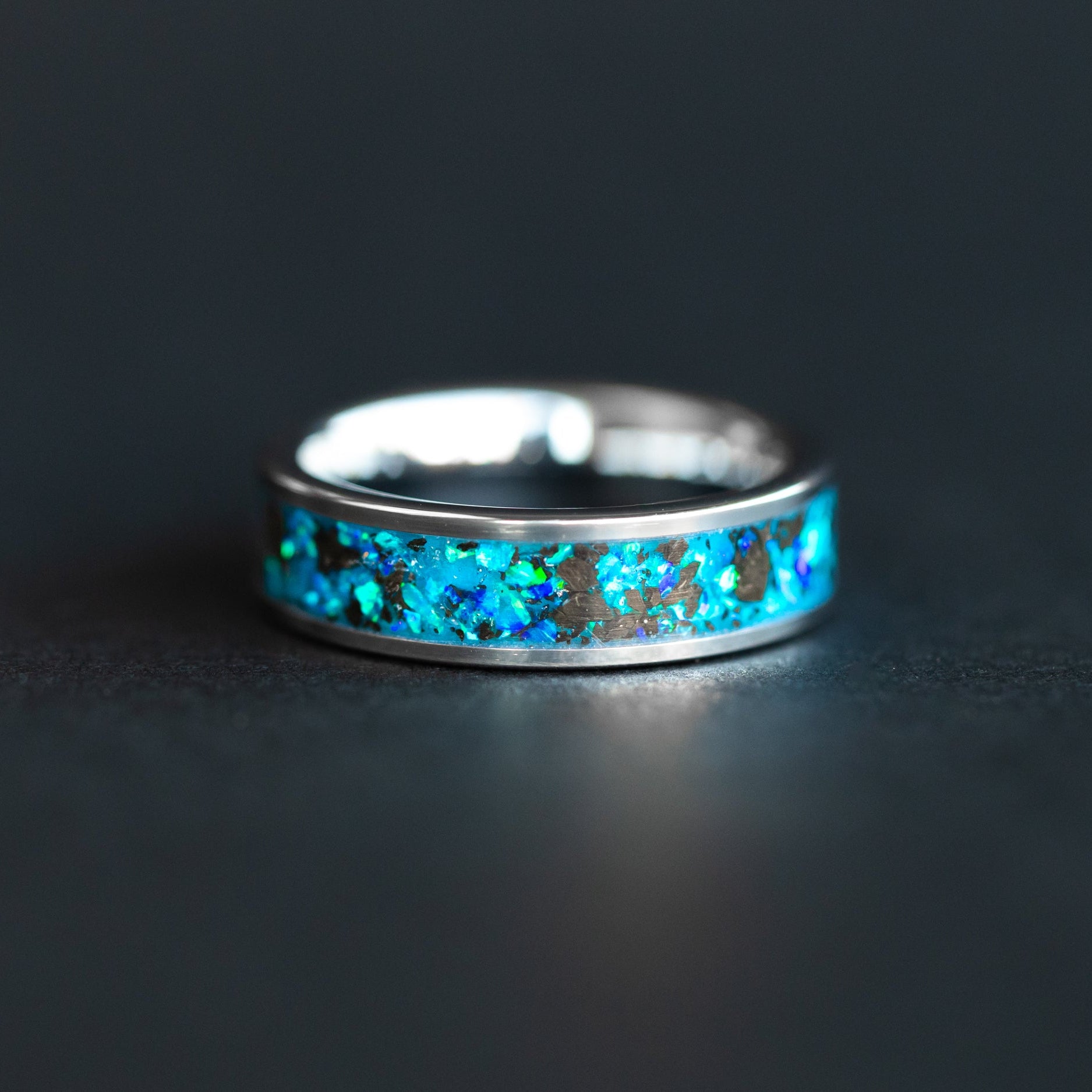 Handcrafted 6mm tungsten mens wedding band with authentic Megalodon tooth fossil and blue opal glow in the dark inlay made in California