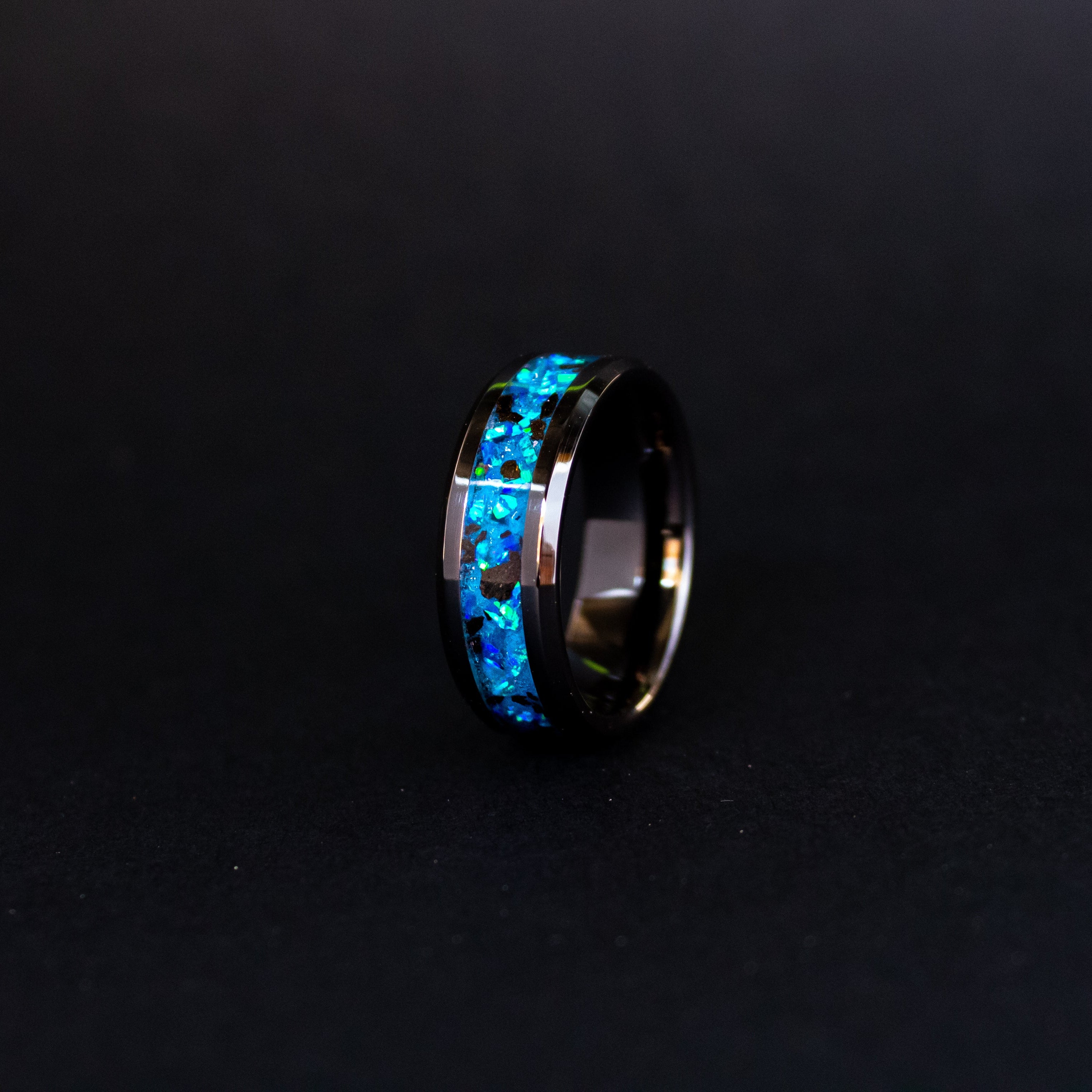 8mm beveled black ceramic ring with authentic Megalodon tooth in blue opal inlay glowing blue in the dark