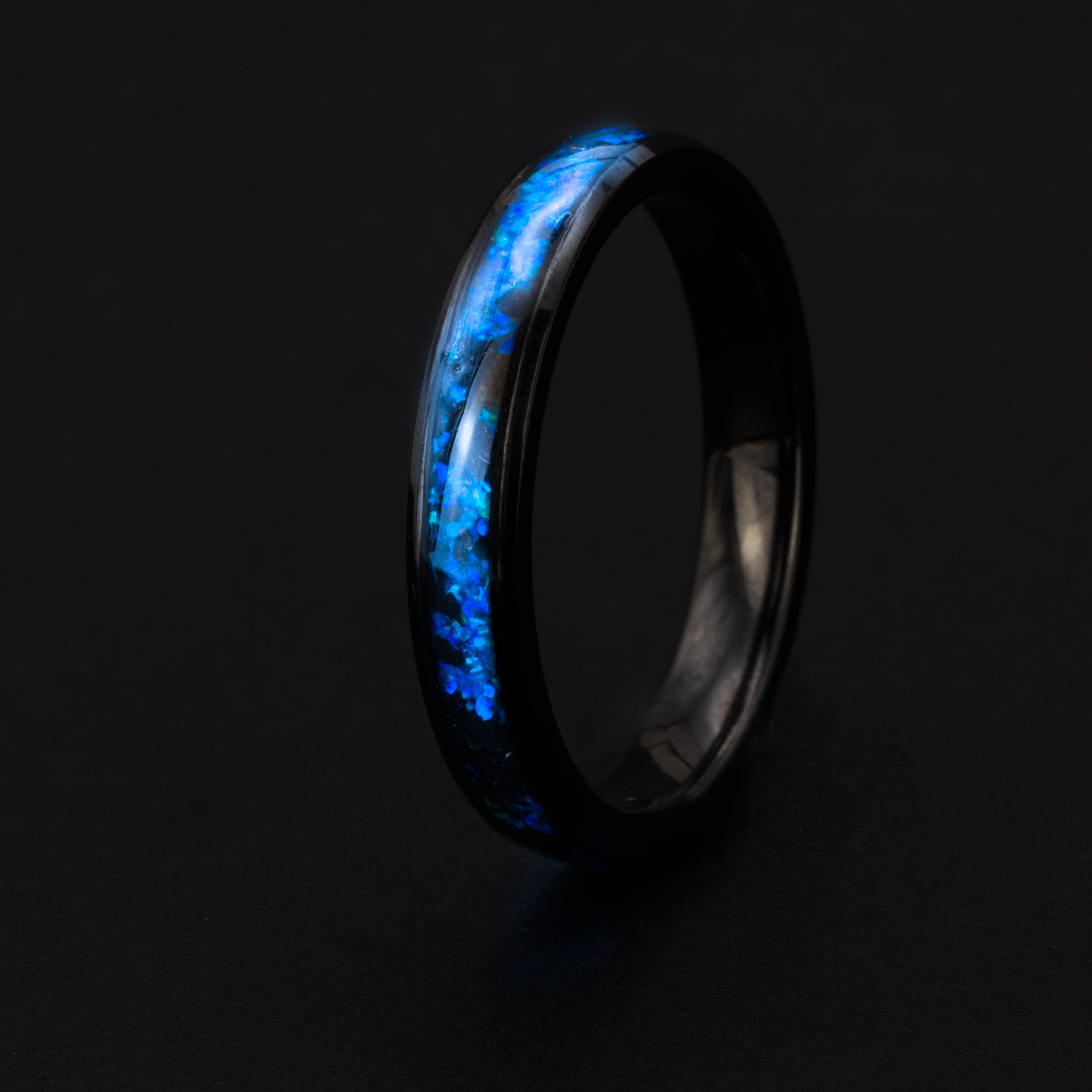 4mm beveled black ceramic ring with authentic Megalodon tooth in blue opal inlay glowing blue in the dark