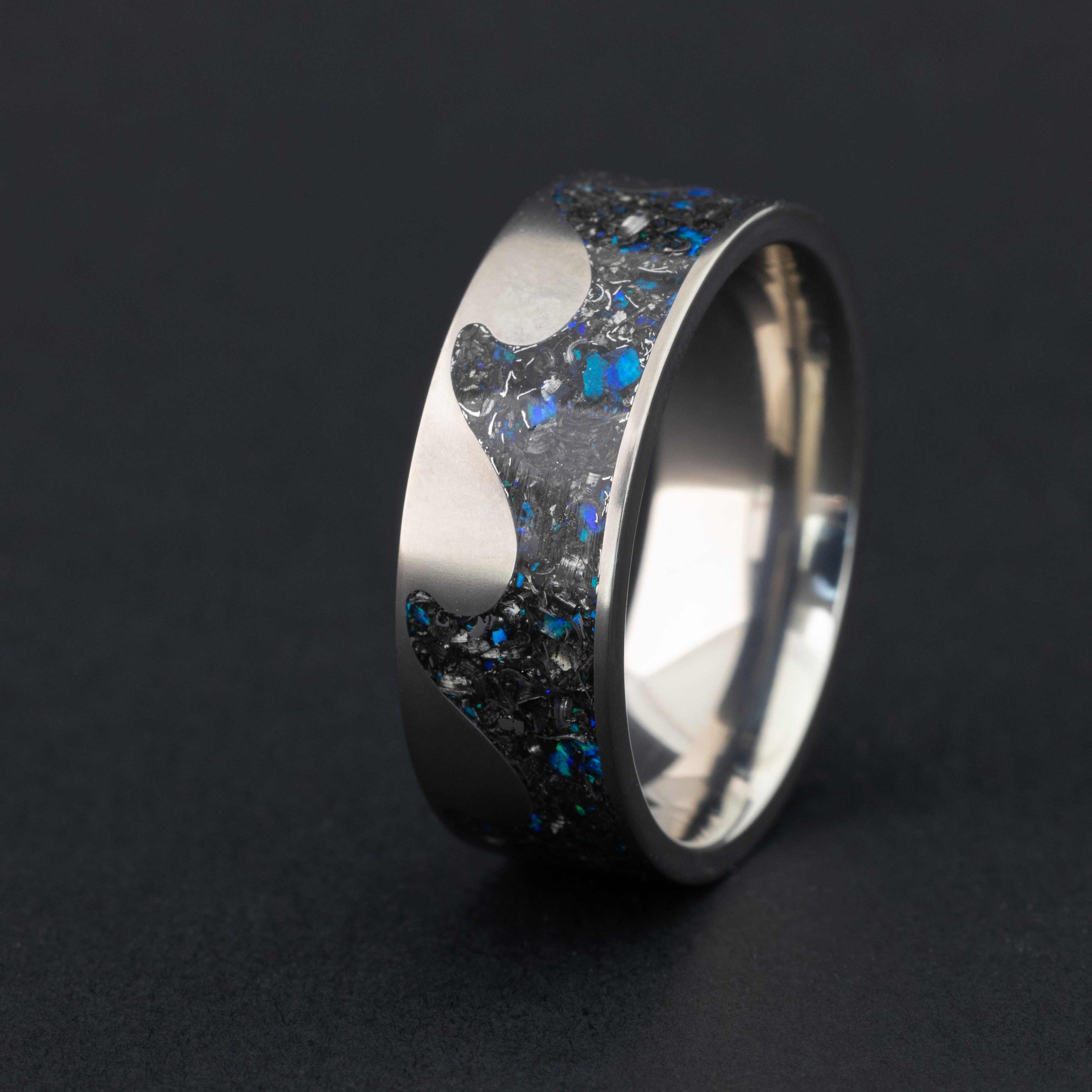 8mm titanium riptide band ring with ocean wave cutout pattern featuring authentic Campo del Cielo meteorite pieces and blue opal accents