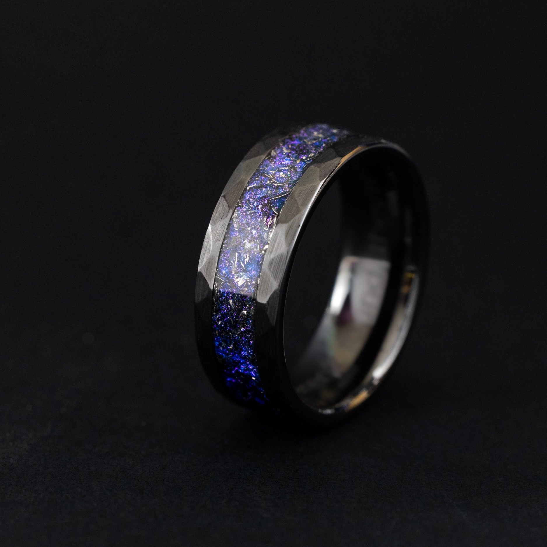 Hammered black ceramic ring with authentic meteorite and iridescent blue and purple nebula inlay.