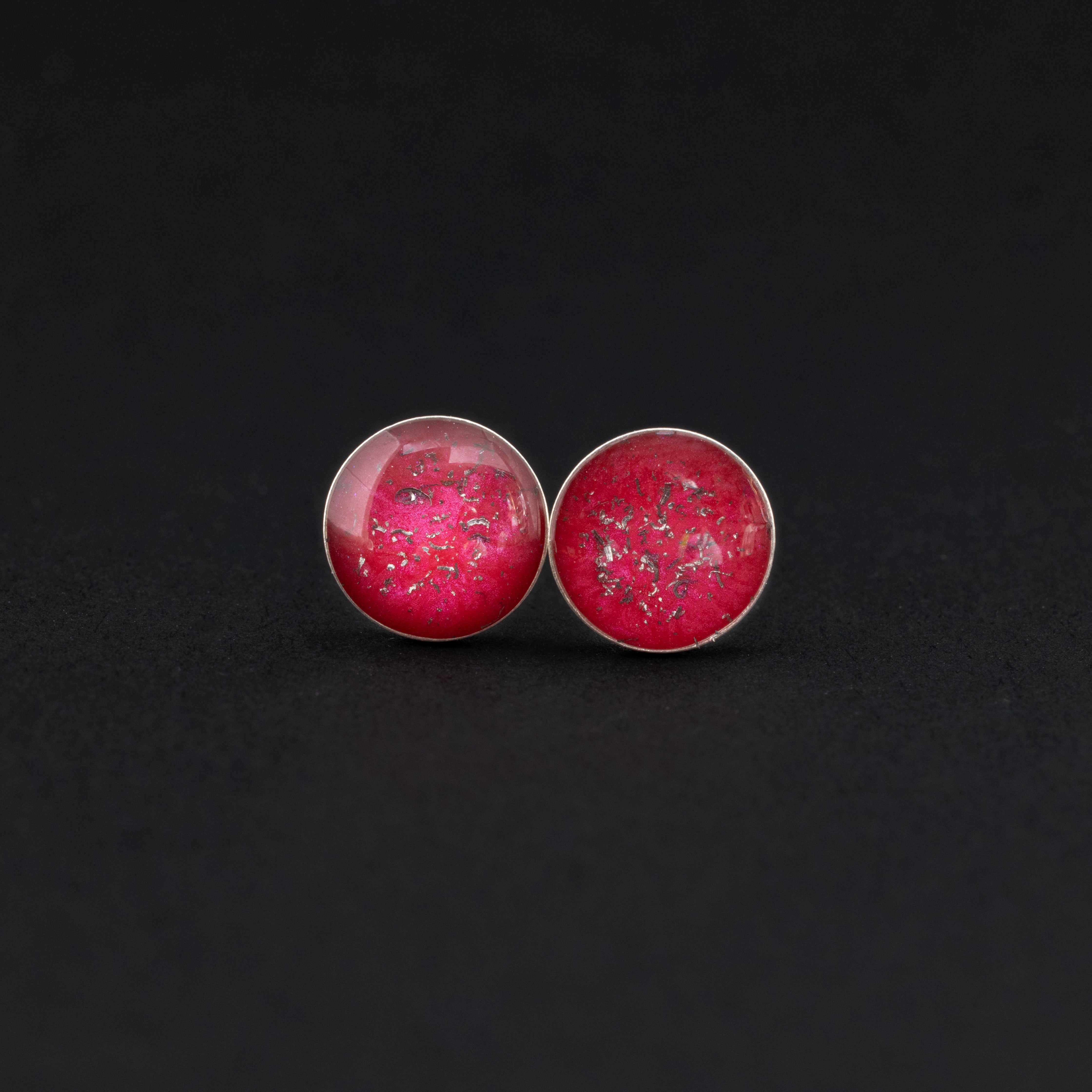 Close-up of the Cherry Studs red stud earrings showing Campo Del Cielo iron meteorite set in deep cherry red resin in sterling silver
