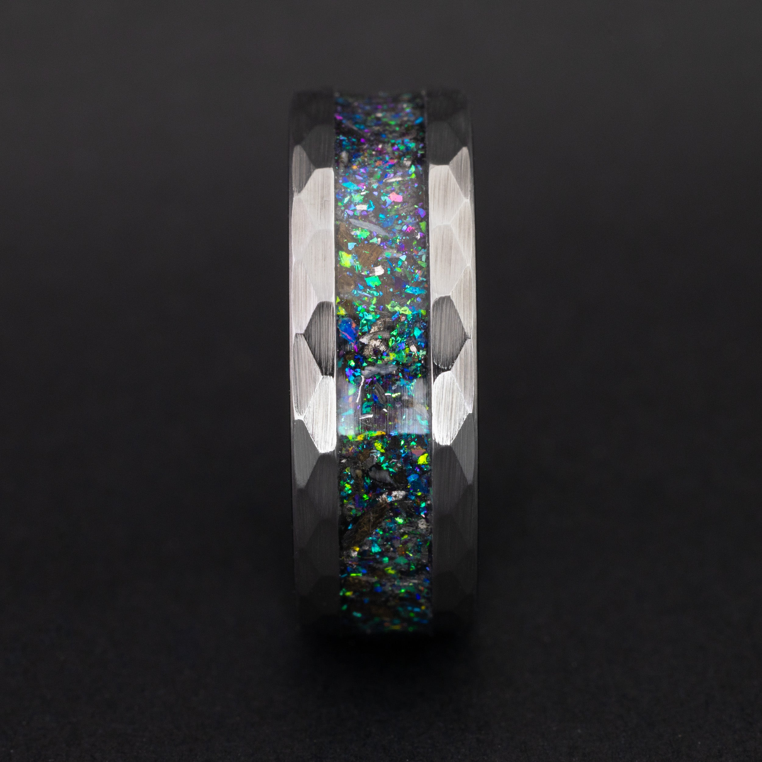 Close up of genuine Megalodon fossil and meteorite shavings in a color-shifting blue and purple ring.