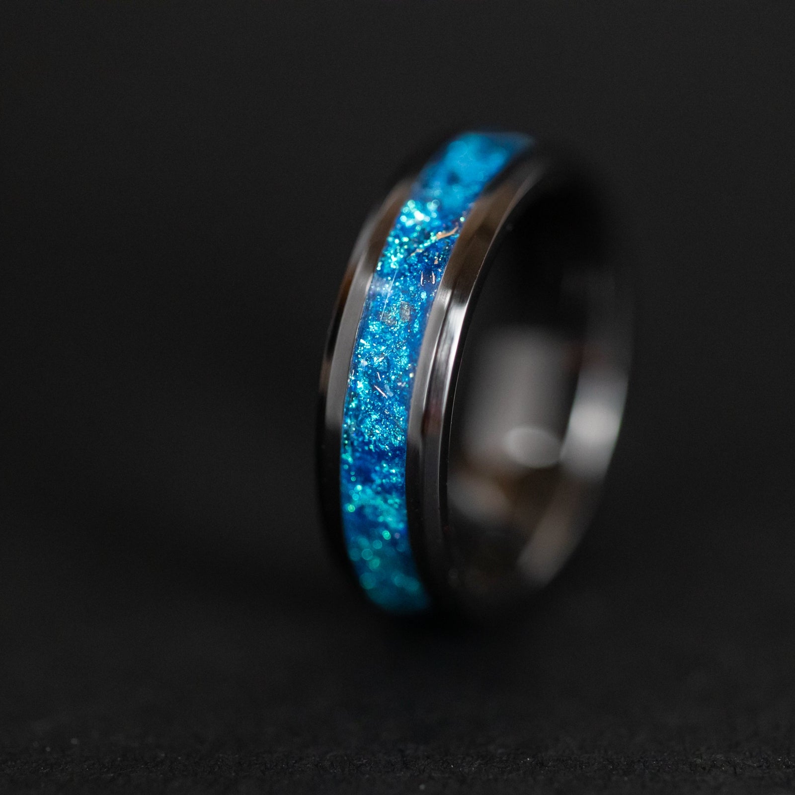 6mm beveled black ceramic ring with authentic Campo del Cielo meteorite shavings suspended in blue glitter pigment inlay