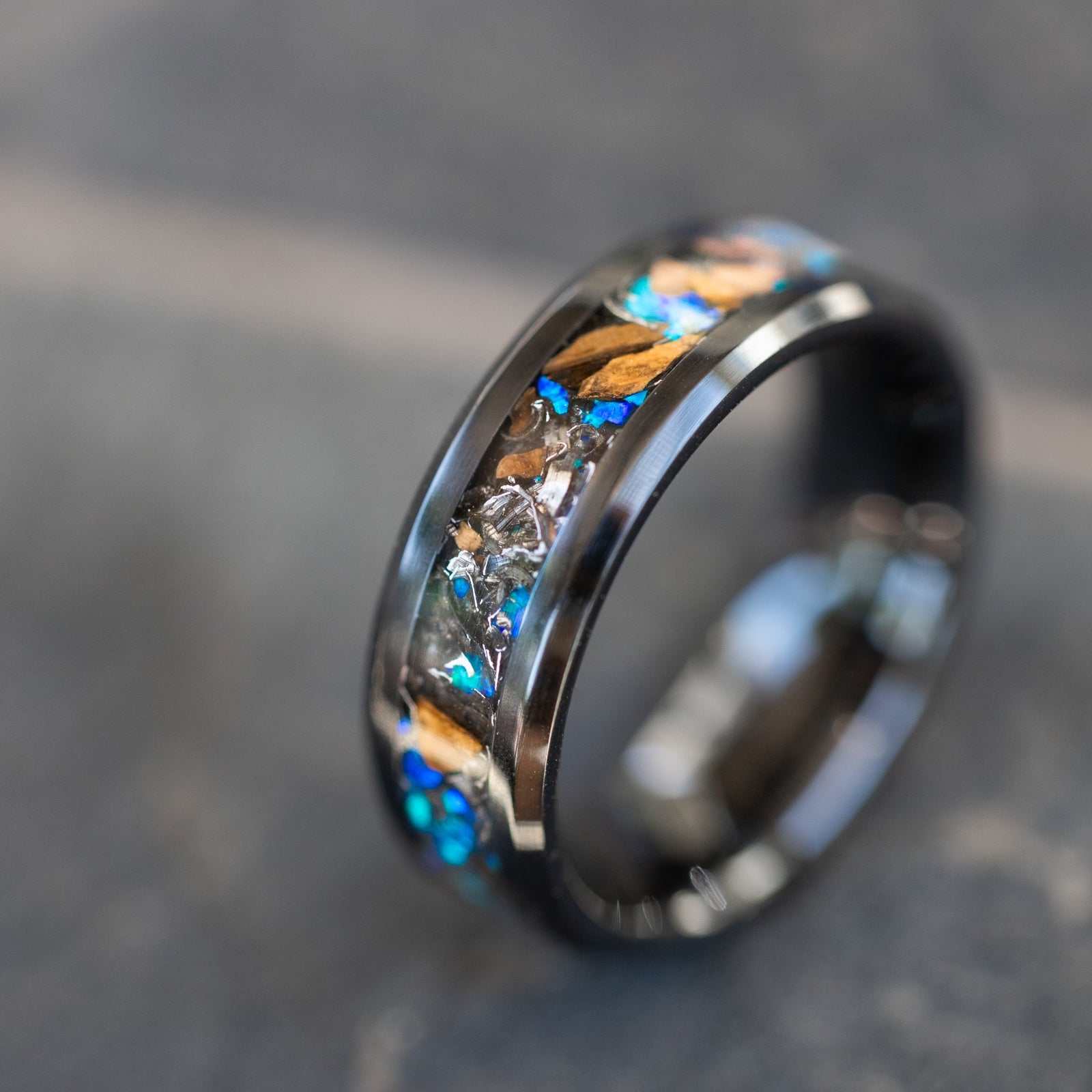 8mm beveled black ceramic ring with authentic Velociraptor bone and Campo del Cielo meteorite in blue opal inlay
