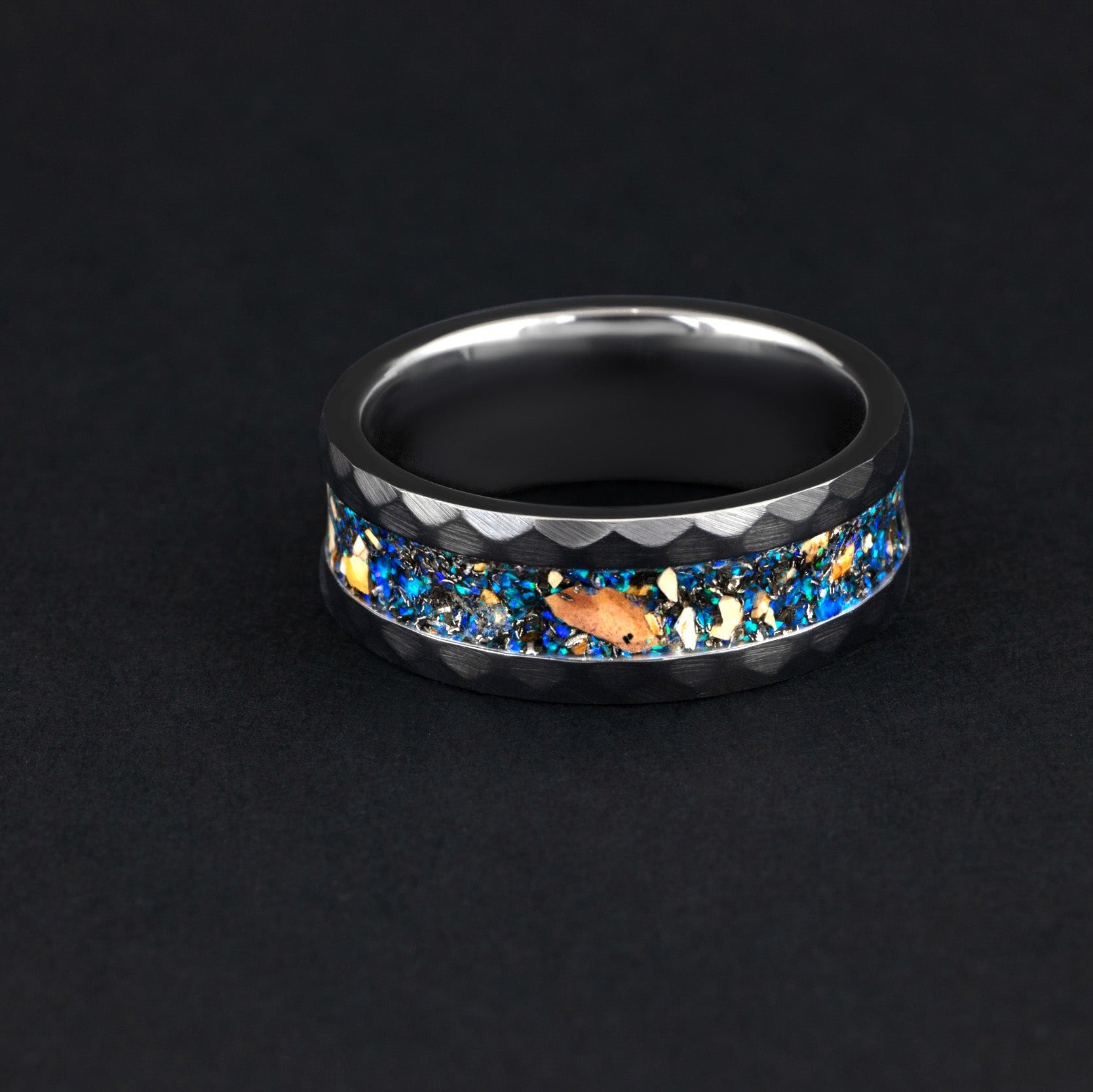 Handcrafted Velociraptor bone and meteorite ring with blue fire opal in a black ceramic band.