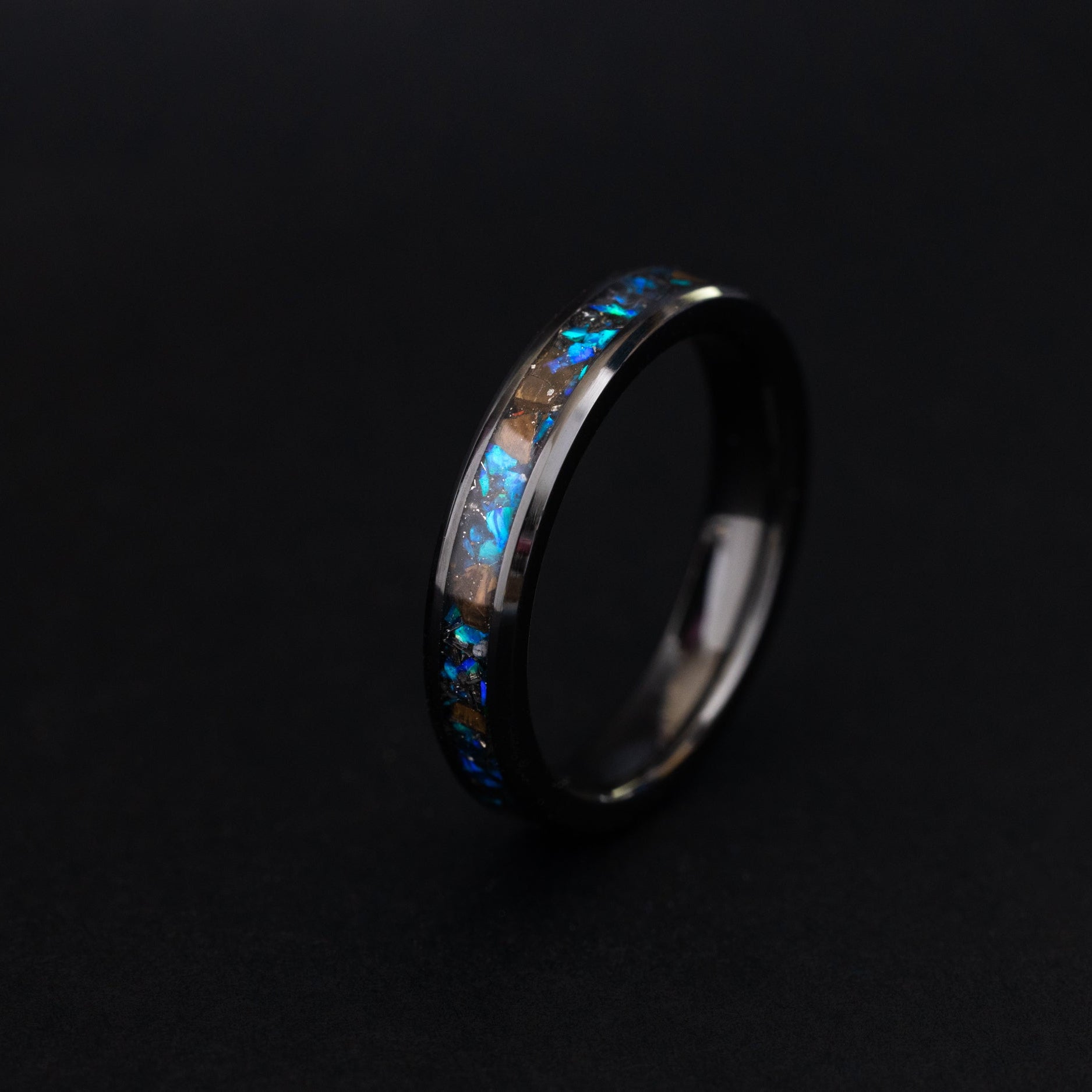 4mm black ceramic ring with authentic T-Rex bone, meteorite, and blue opal inlay.