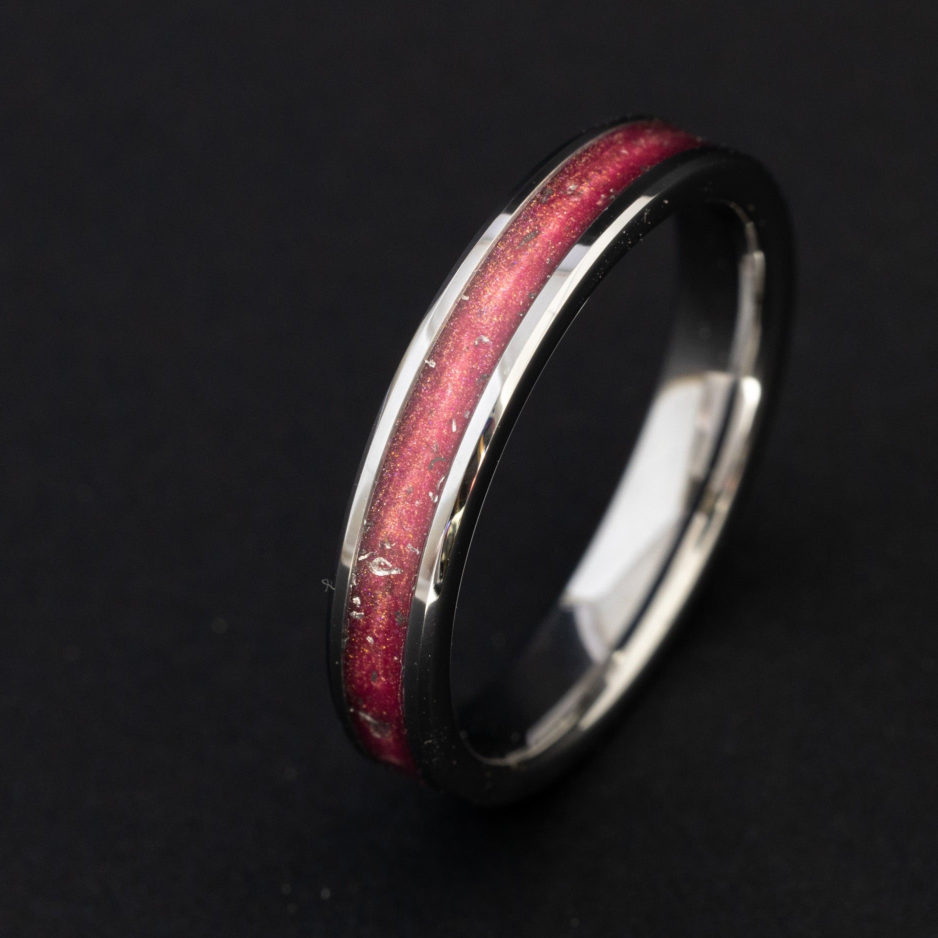 4mm tungsten wedding band featuring celestial meteorite fragments and metallic pink inlay.