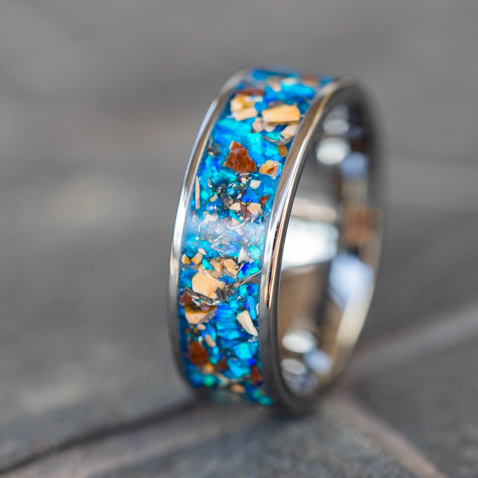 8mm wide channel tungsten ring with authentic Mosasaur bone, Dinosaur Gembone, and Campo del Cielo meteorite in blue opal inlay glowing blue in the dark