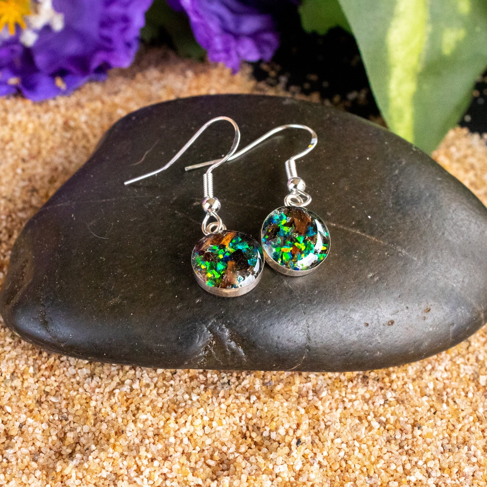 Close-up of the Emerald TRex Dangle showing Campo Del Cielo iron meteorite, real T-Rex bone, and bright green opal in each earring