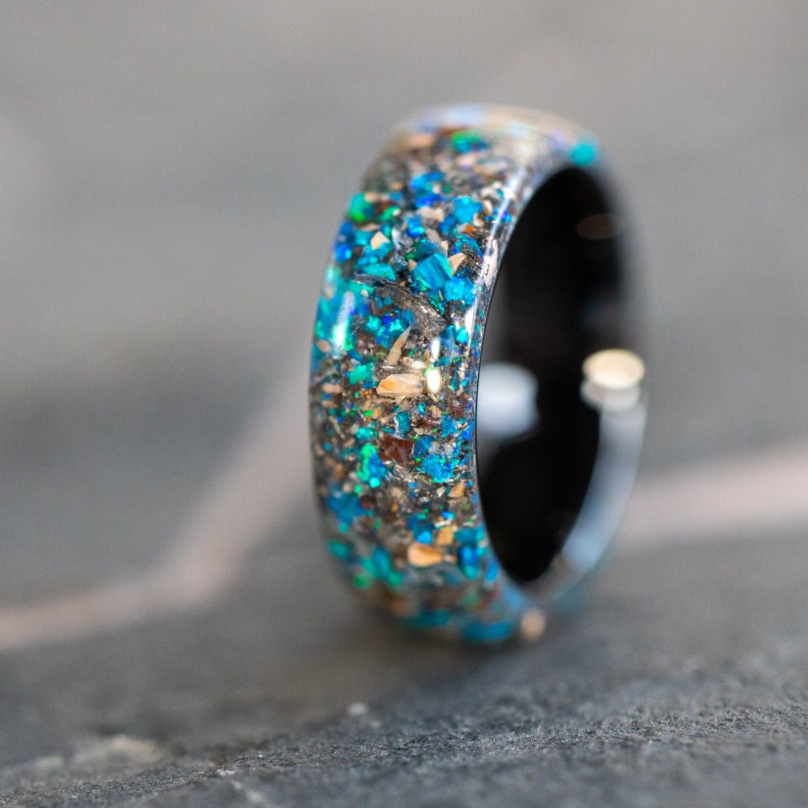 Endless black ceramic ring with authentic Mosasaur bone, Dinosaur Gembone, and Campo del Cielo meteorite in blue opal inlay