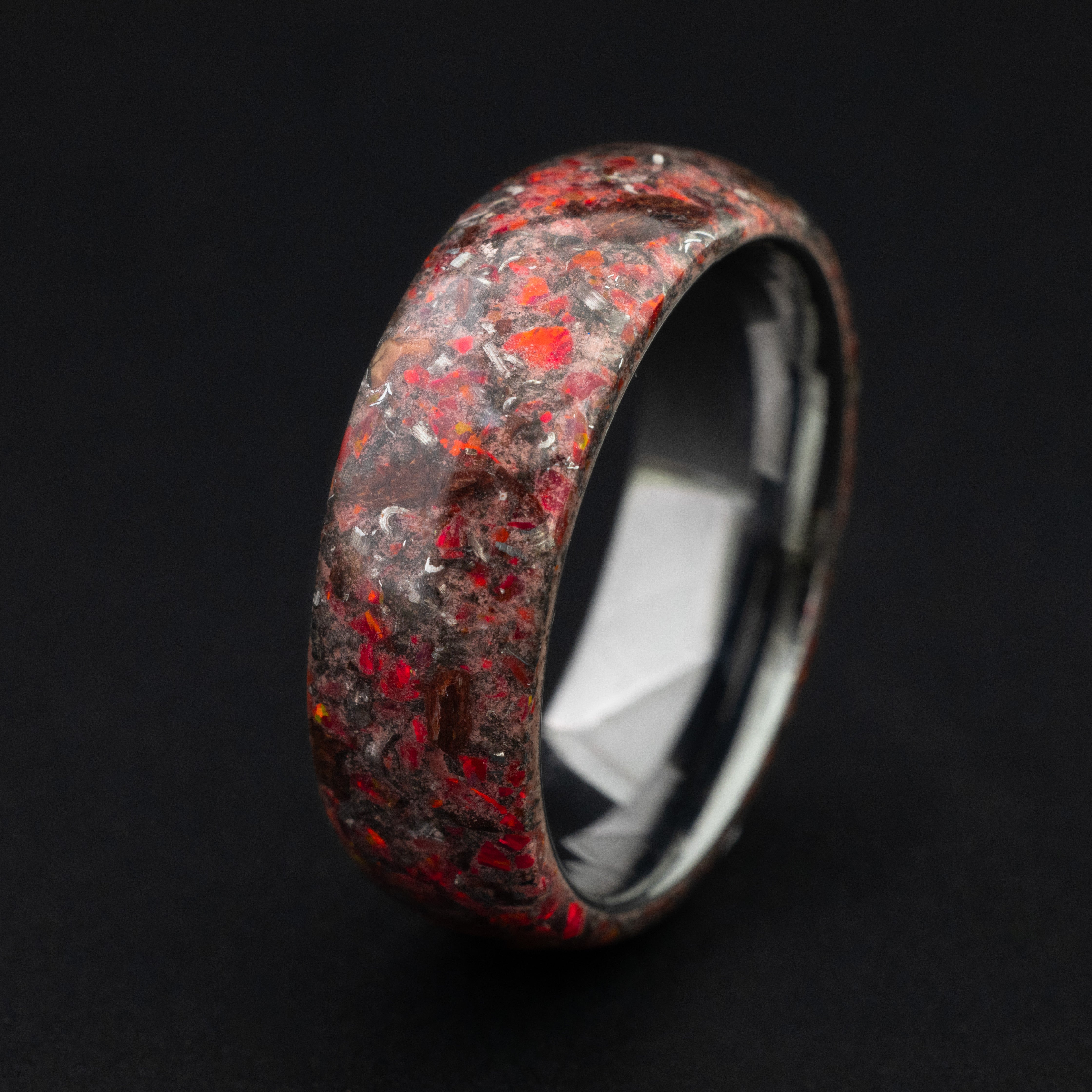 Handcrafted seamless T-Rex bone and meteorite ring with red opal and red glow-in-the-dark effects.
