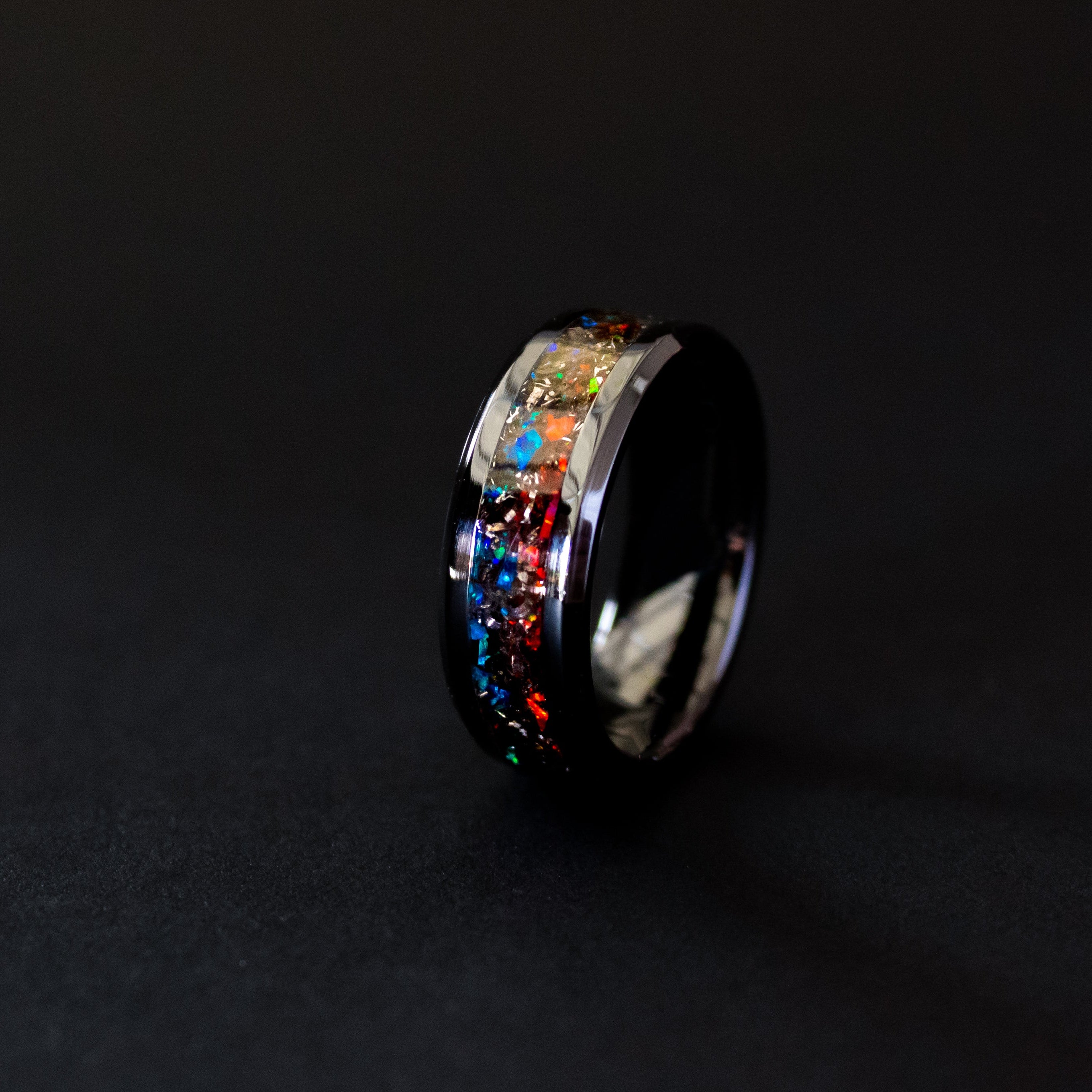 8mm beveled black ceramic ring with authentic Campo del Cielo meteorite shavings in split red and blue opal inlay