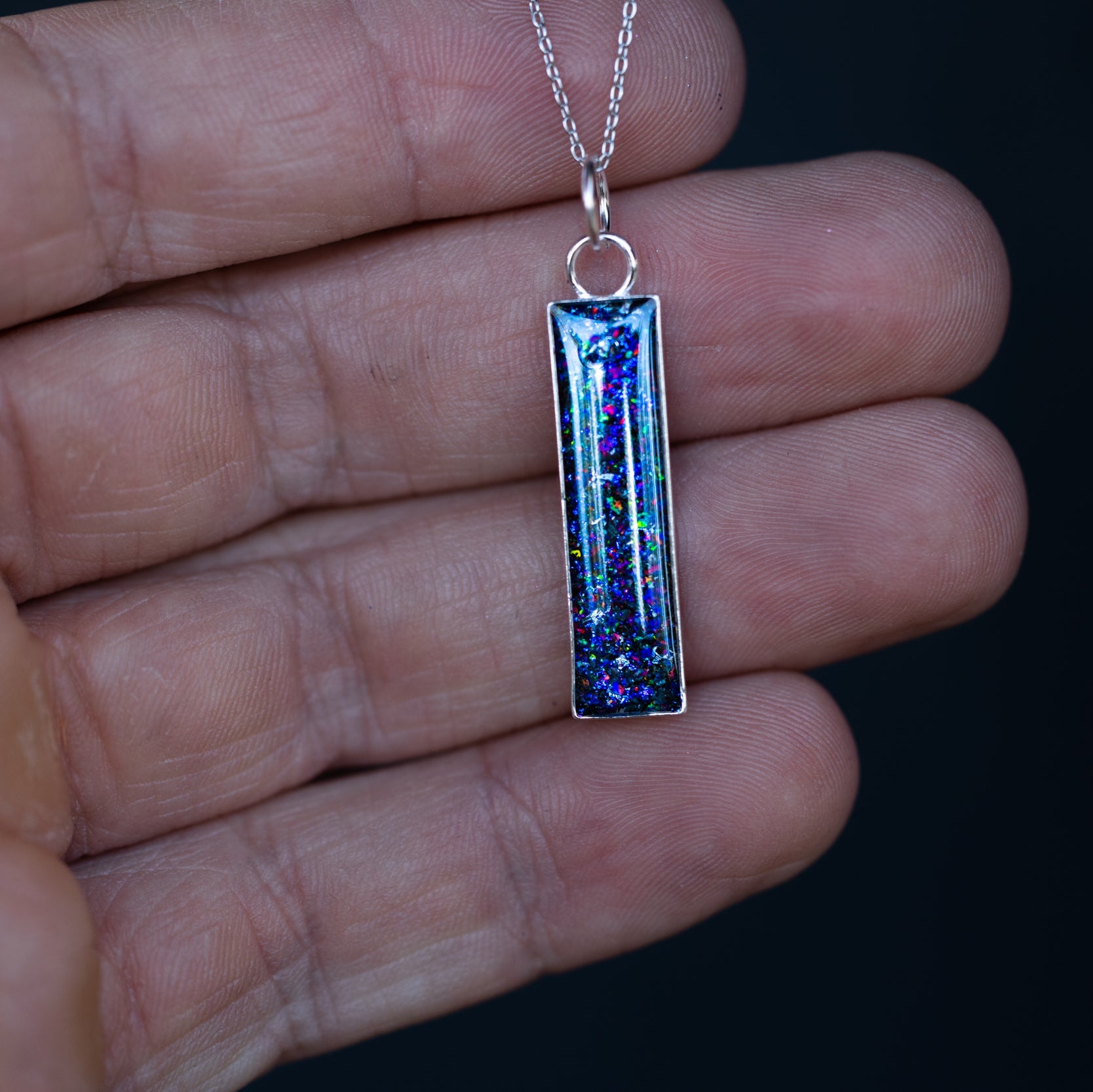 Galaxy Bar Silver opal pendant necklace with Campo Del Cielo meteorite and blue and purple opal inlay shown on a chain, ideal as an October birthstone or galaxy necklace gift