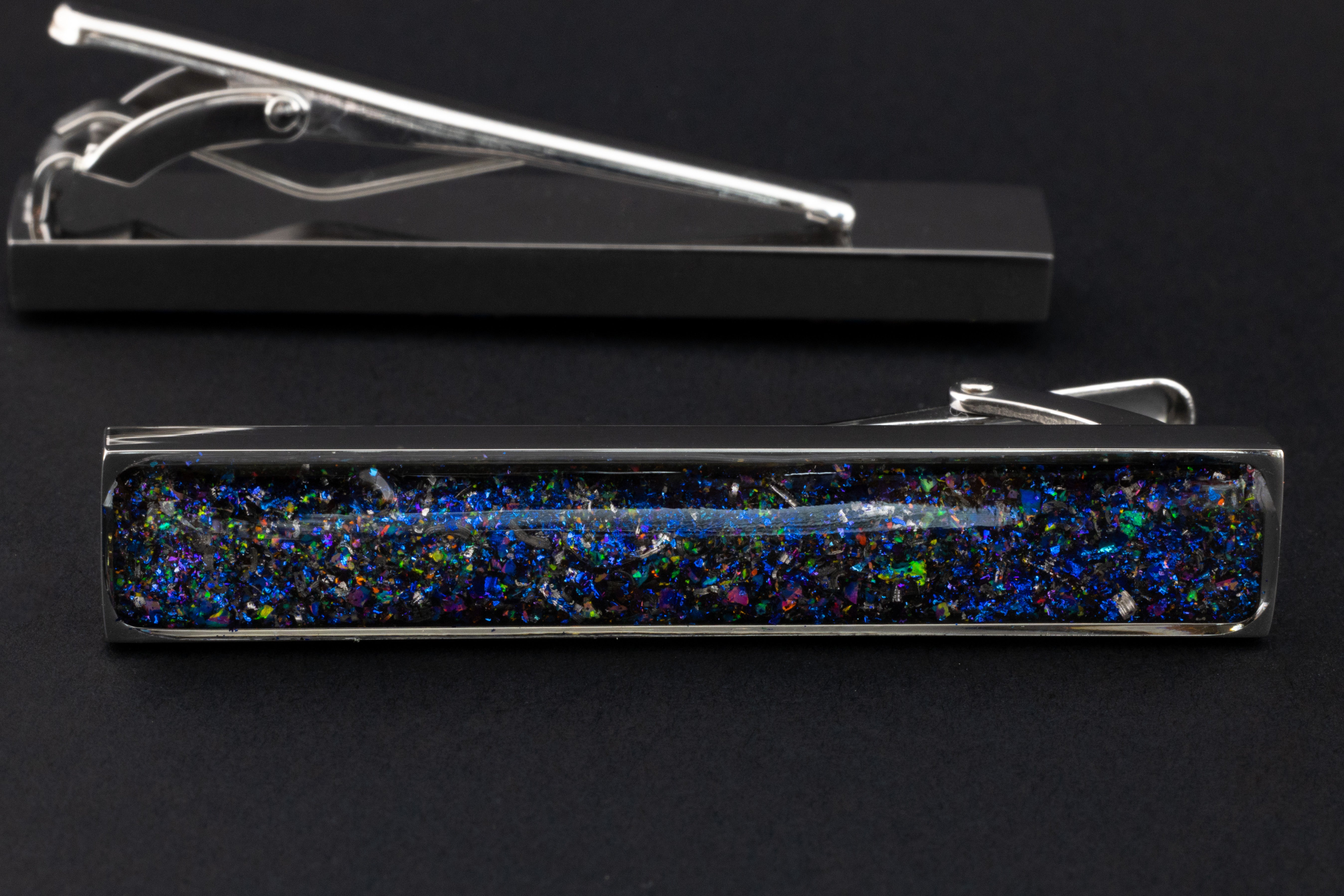 Close-up of the Galaxy Tie Clip showing Campo Del Cielo iron meteorite set with a galaxy-inspired blend of blue, purple, pink, green, and white opals and pigment glitter in polished silver-tone stainless steel