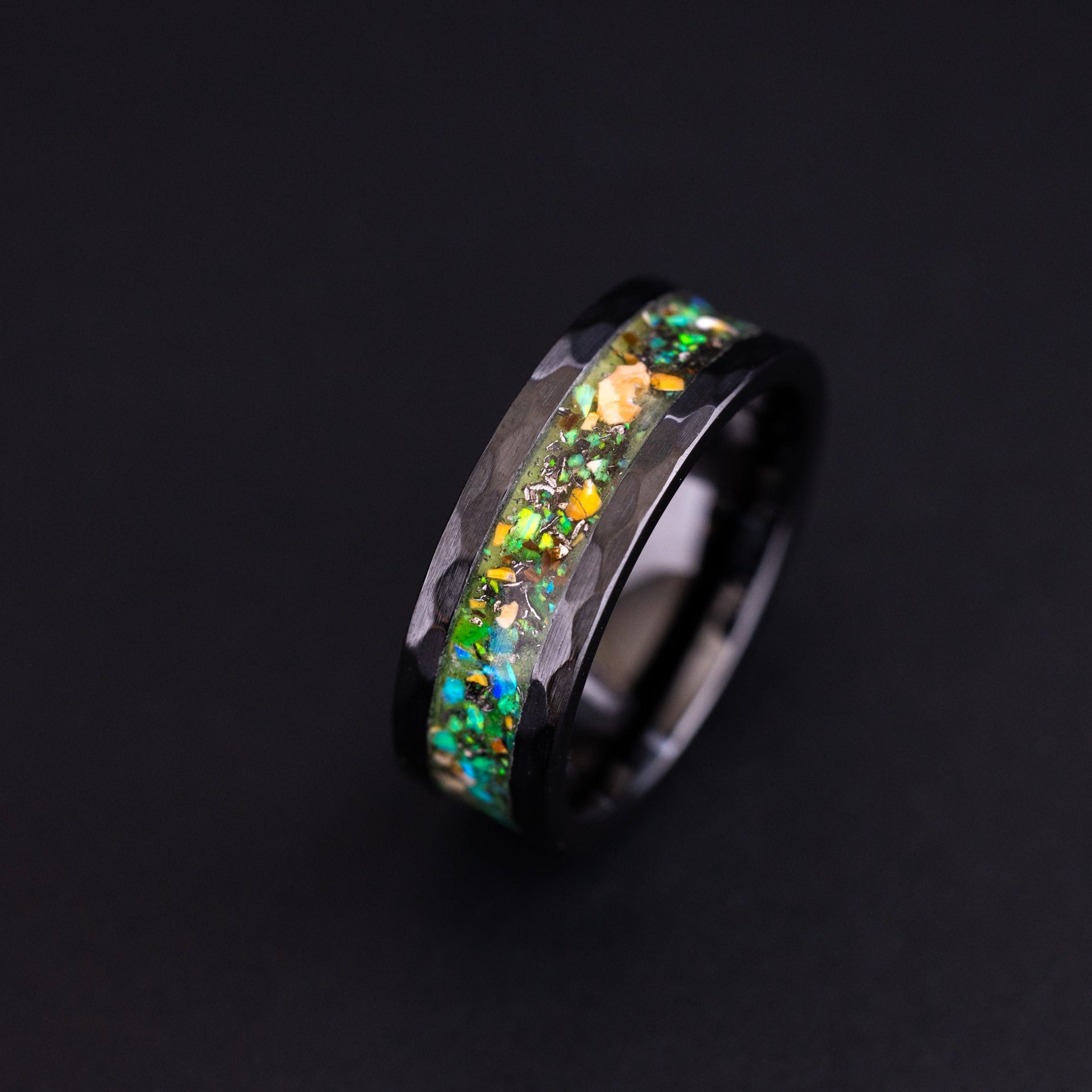 8mm hammered black ceramic ring with authentic Velociraptor bone, meteorite, and neon green glow inlay.