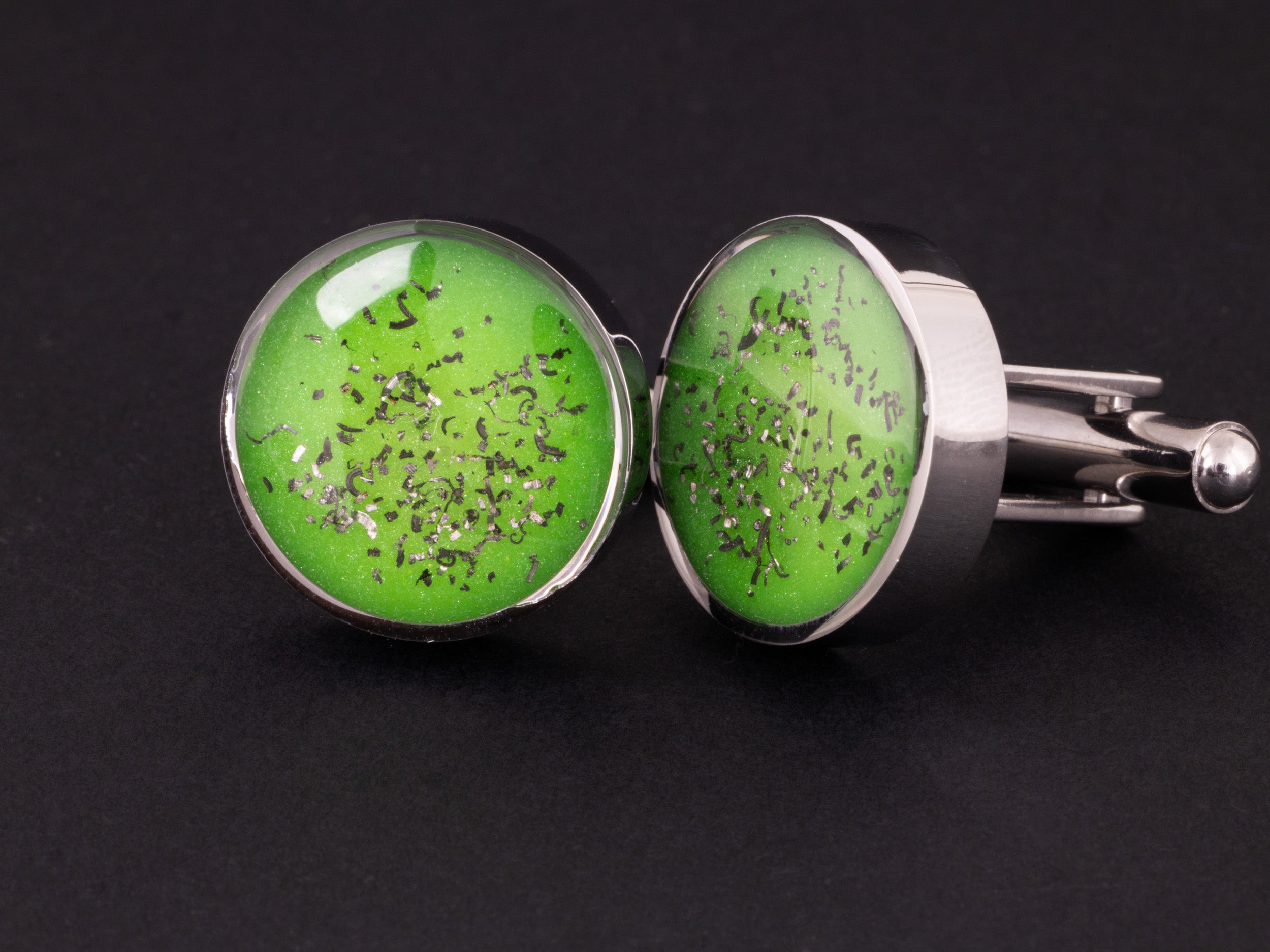 Close-up of the Green Meteorite Cufflinks showing Campo Del Cielo iron meteorite set in lime green resin in polished stainless steel