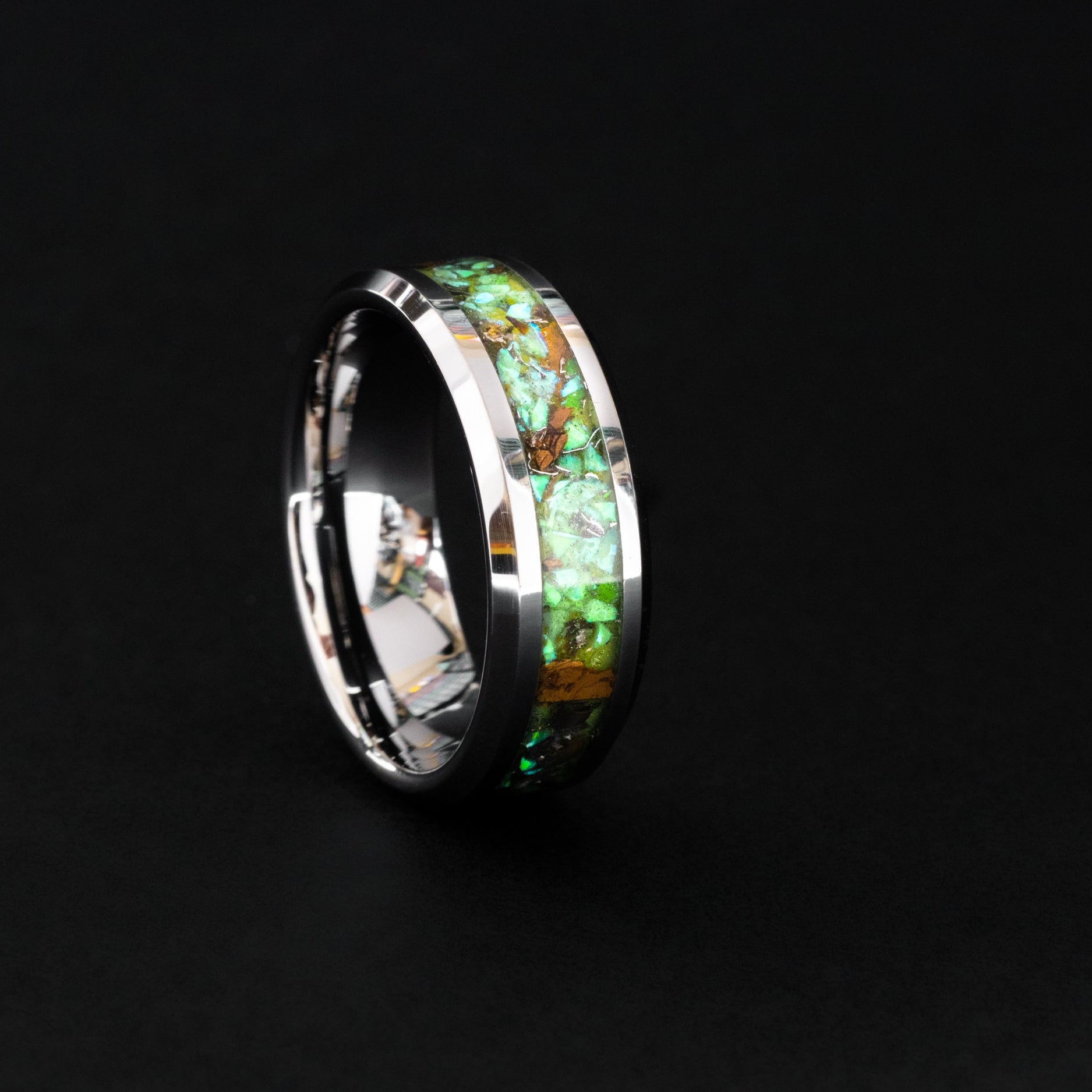 8mm tungsten wedding band featuring prehistoric raptor bone and vibrant green glow.