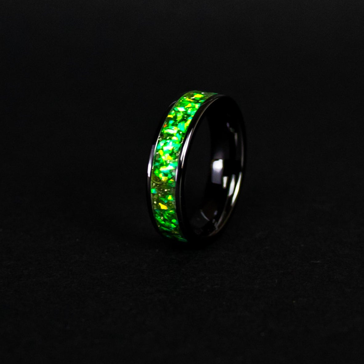6mm wide channel black ceramic ring with authentic Campo del Cielo meteorite shavings in green opal inlay glowing green in the dark