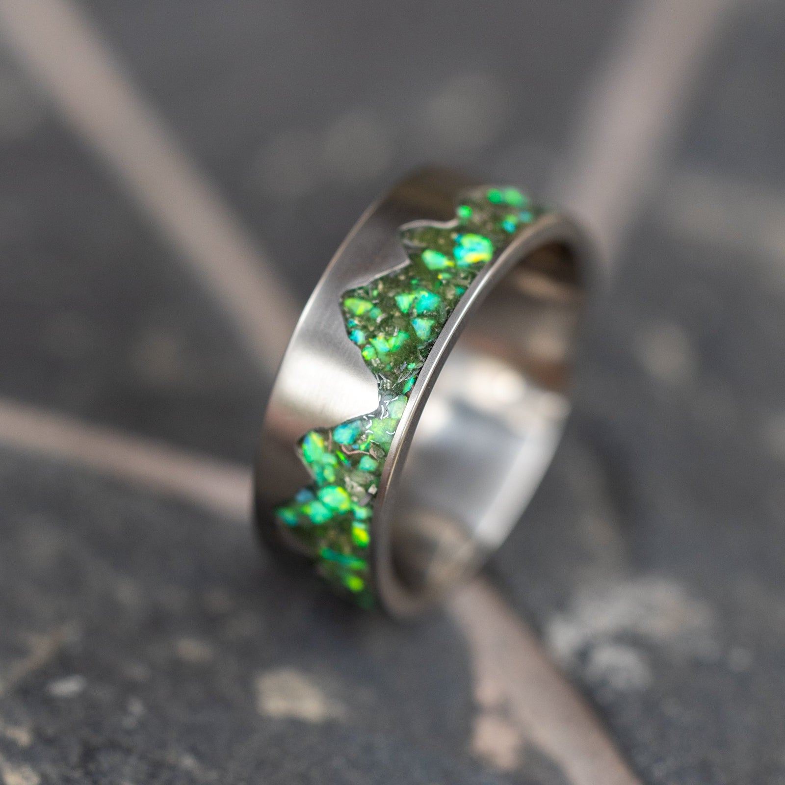 Side profile of the handcrafted titanium Green Ridgeline ring made in a California studio.