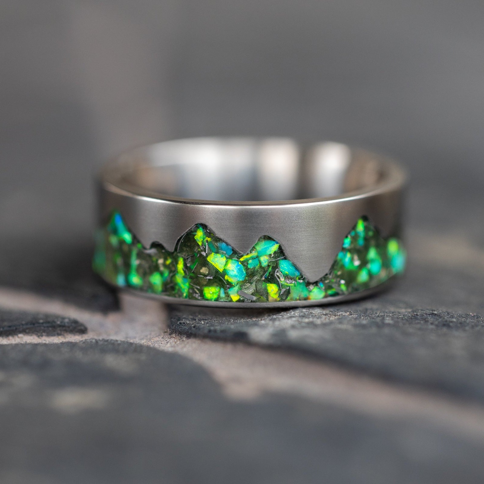 Top view of the Green Ridgeline ring showing the mountain silhouette cutout filled with green opal and meteorite.