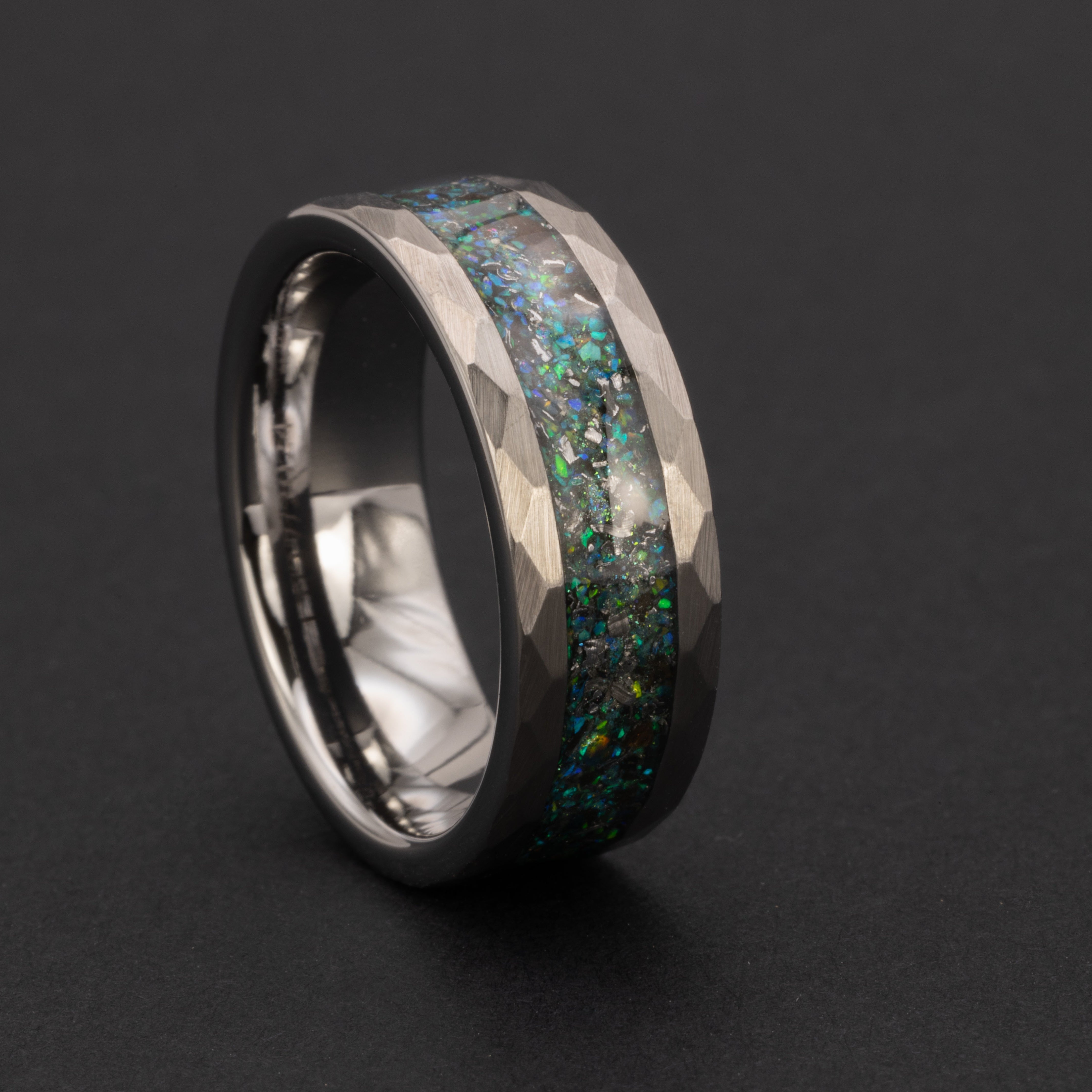 Hammered Megalodon Glow ring glowing blue in total darkness showing Megalodon tooth and meteorite suspended in electric blue glow in the dark inlay