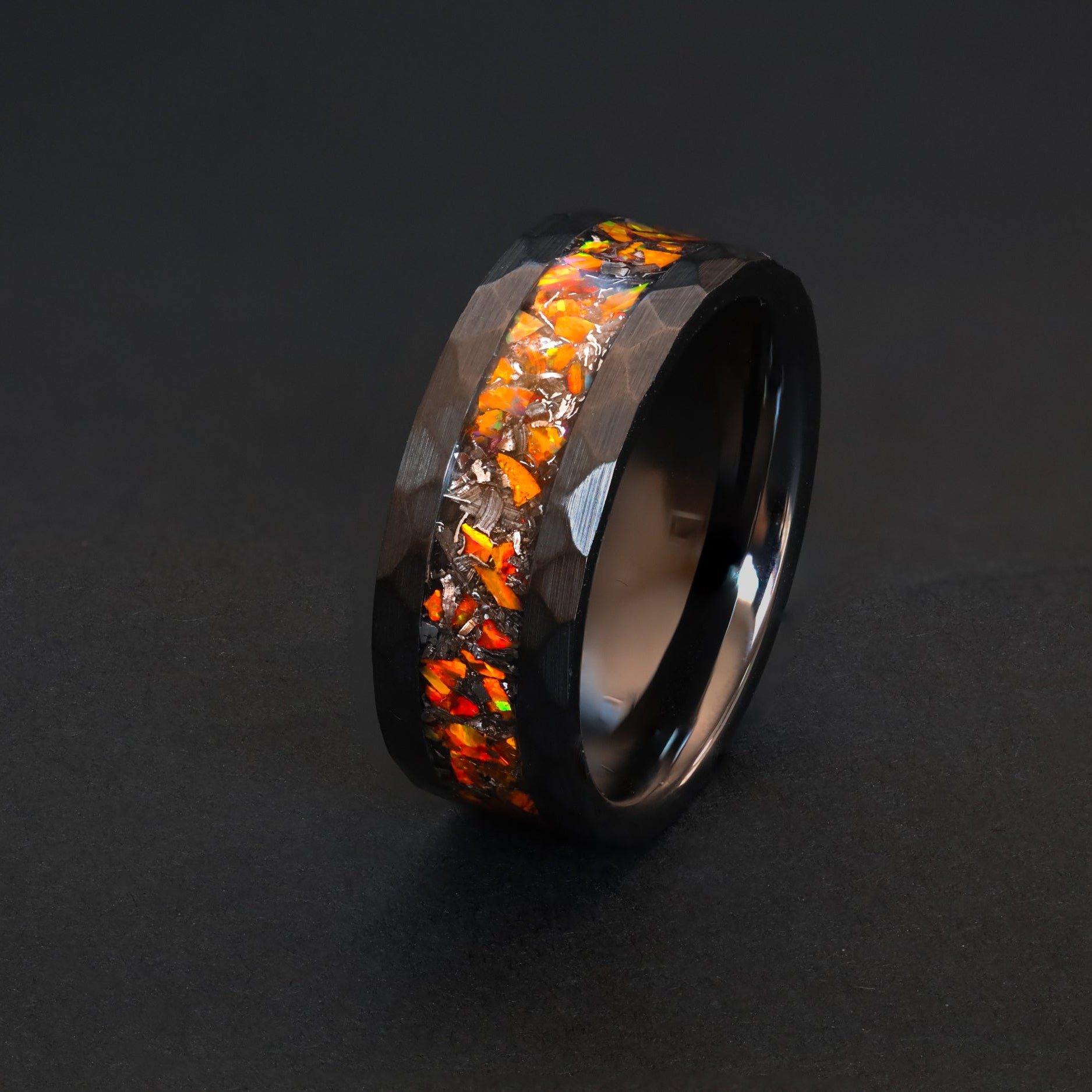 Hammered black ceramic ring with authentic meteorite and fiery orange opal inlay.