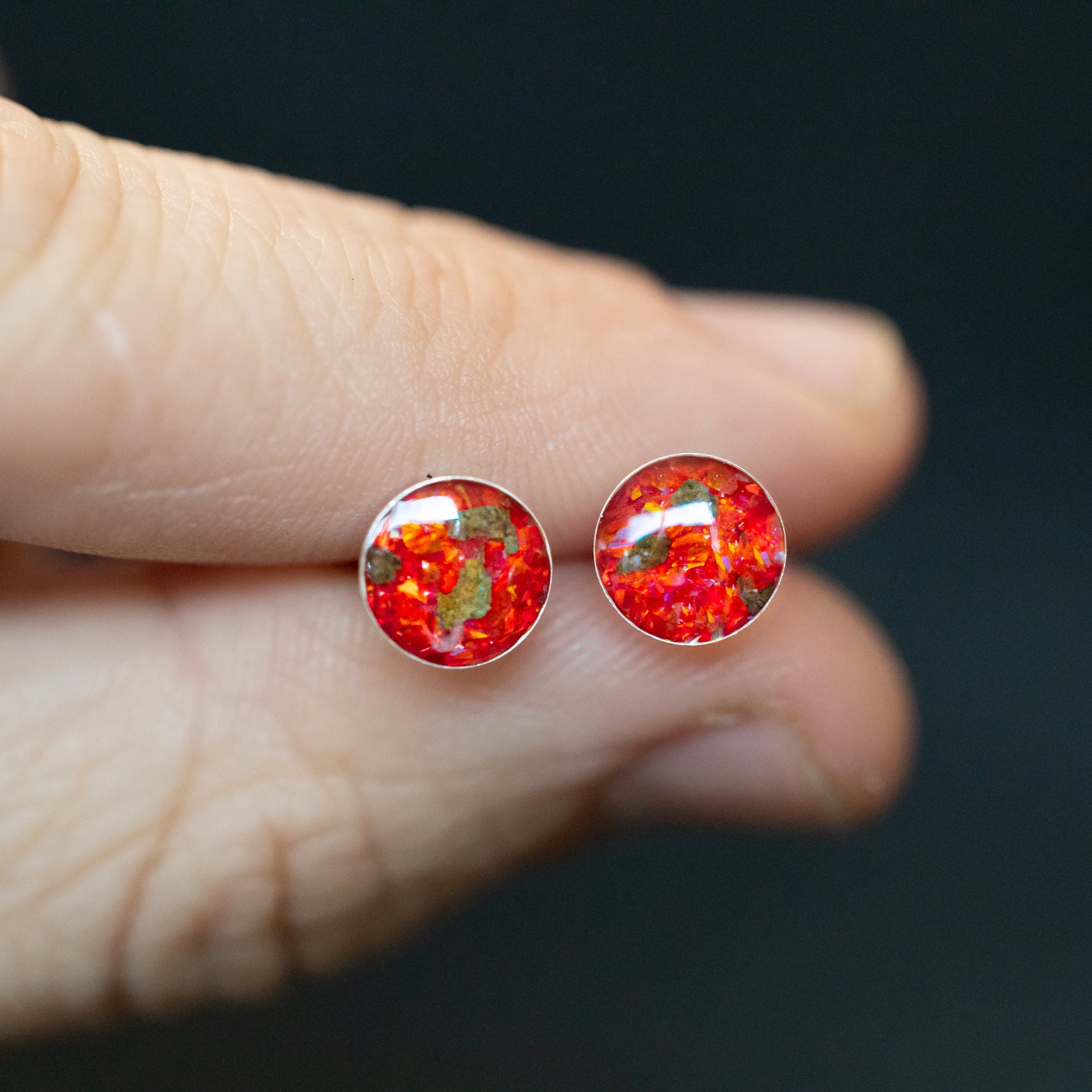 Close-up of the Martian Red Studs Mars earrings showing a real piece of Mars set with vivid red opal in sterling silver