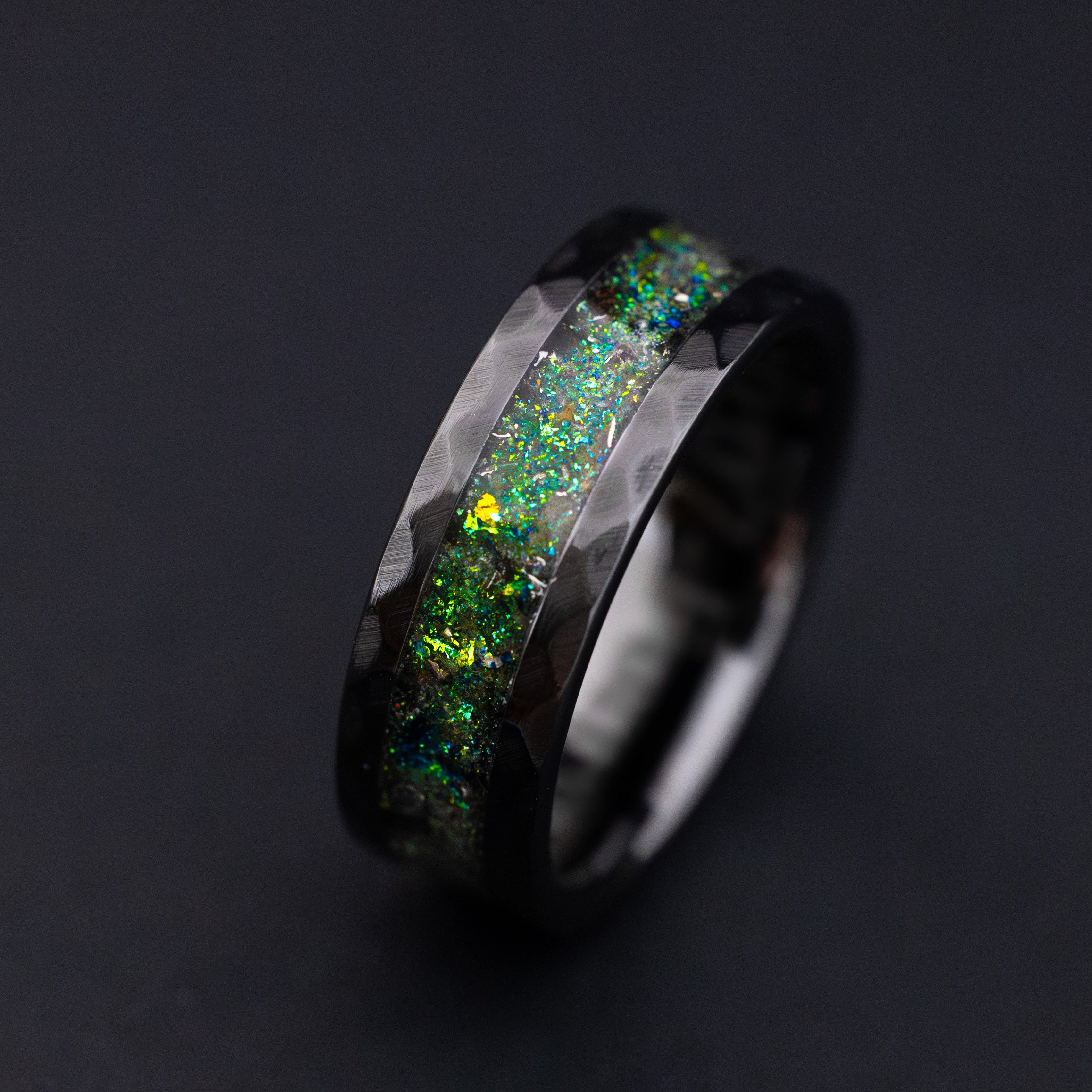 Cinematic view of the Megalodon Hammered Glow ring shifting from daylight shimmer to teal night glow