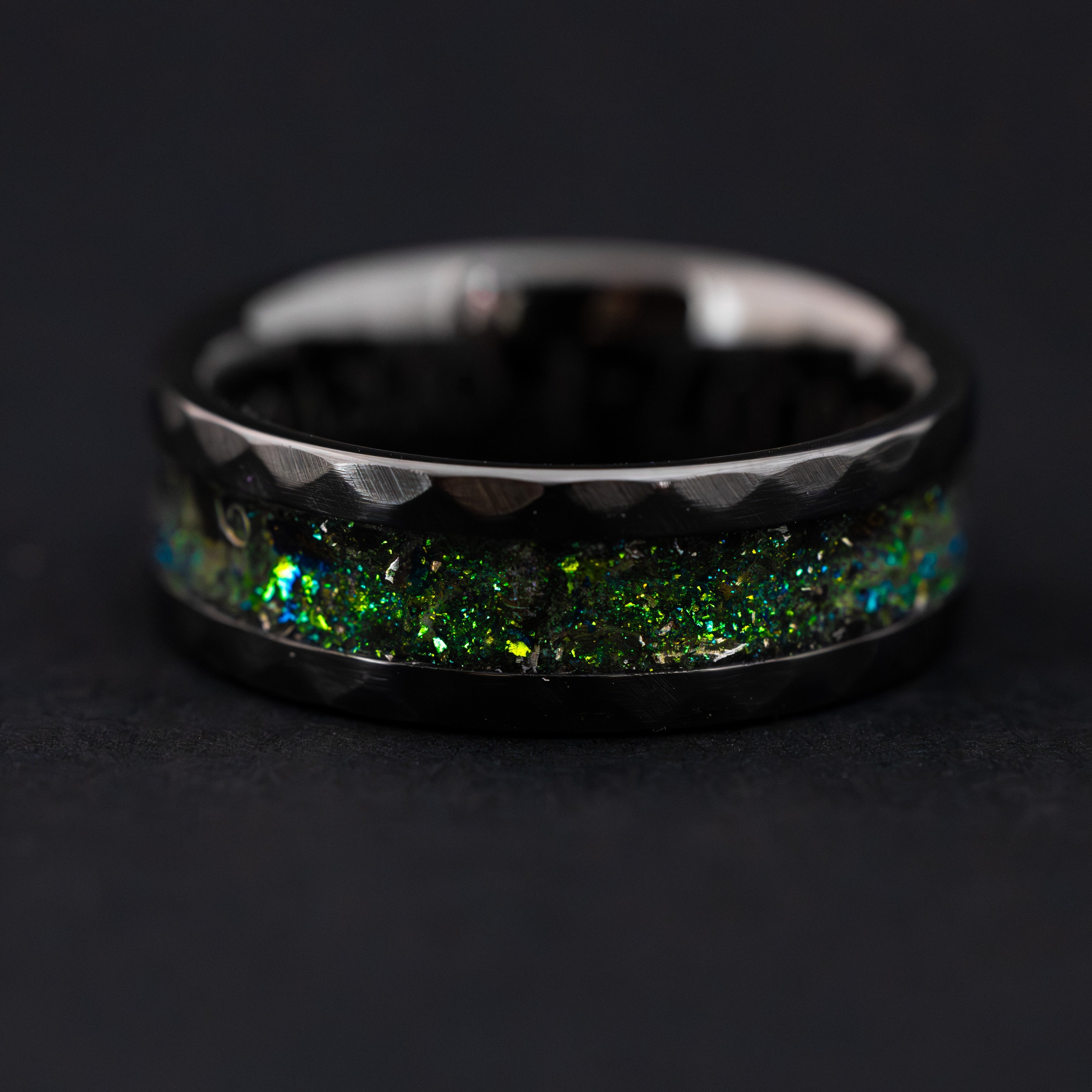 Megalodon tooth and Campo meteorite shavings in a hammered black ceramic ring.
