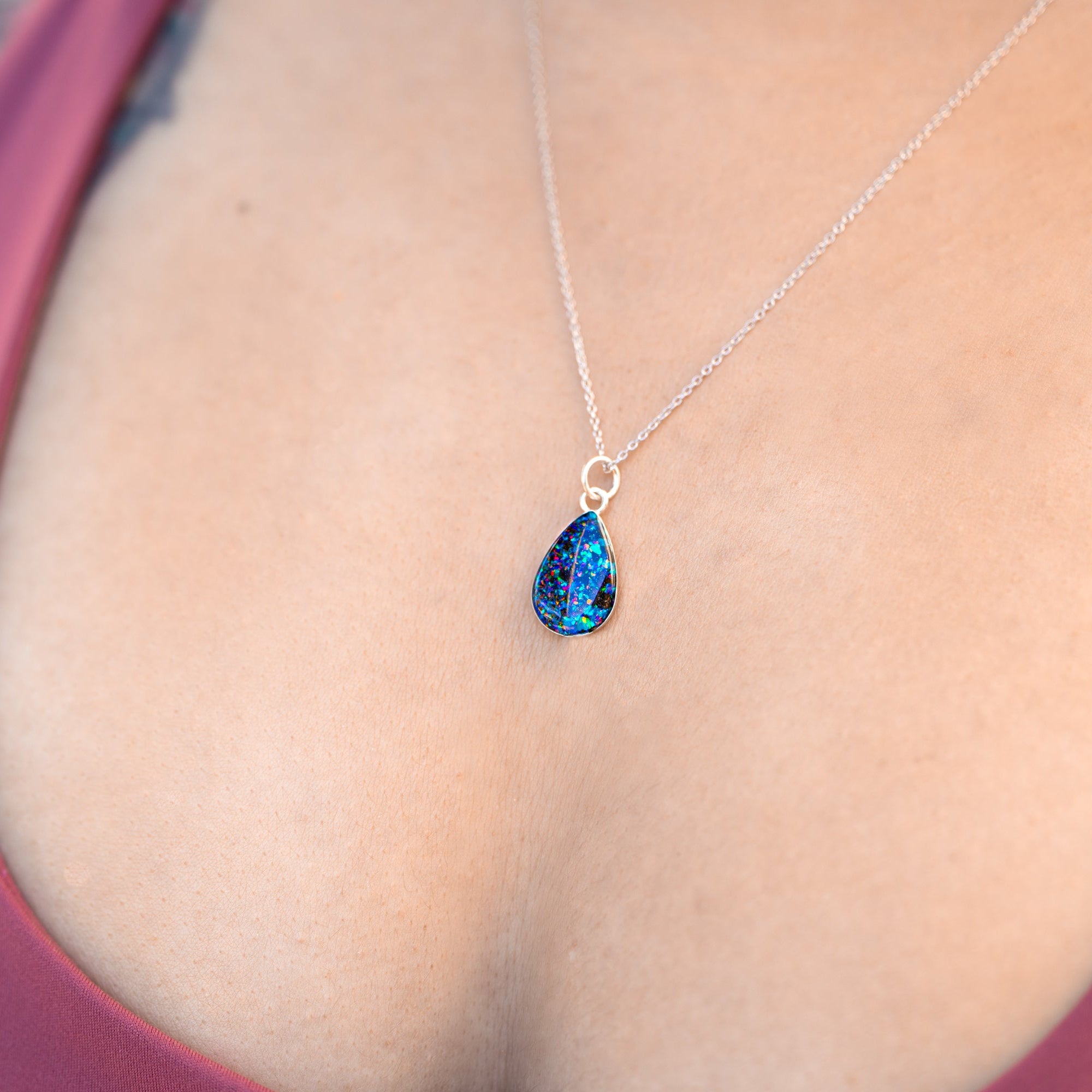 Handcrafted shark tooth fossil teardrop pendant necklace in sterling silver with real megalodon tooth and blue and purple opal inlay