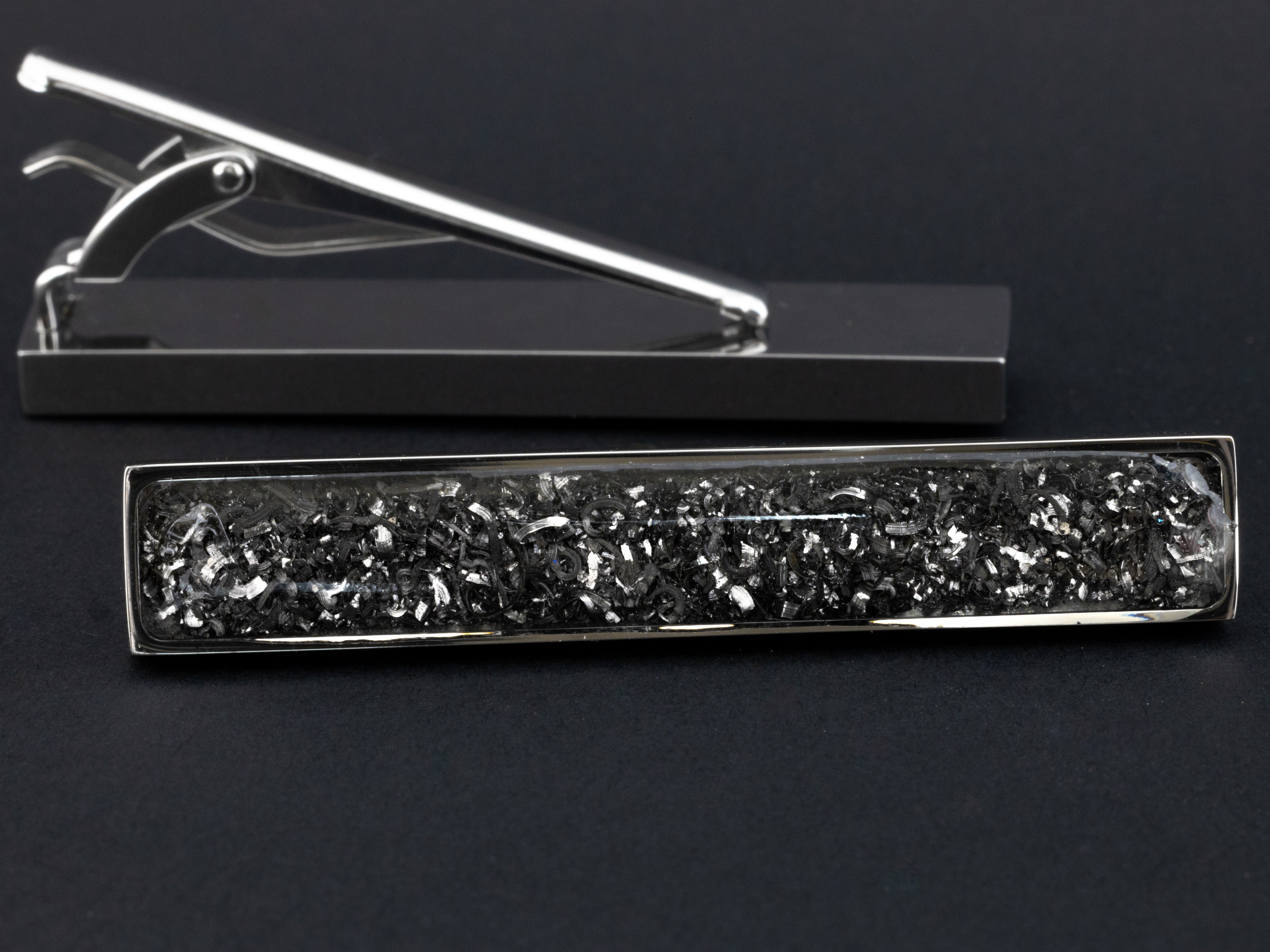 Close-up of the Meteorite Tie Clip showing real Campo Del Cielo iron meteorite set in polished silver-tone stainless steel