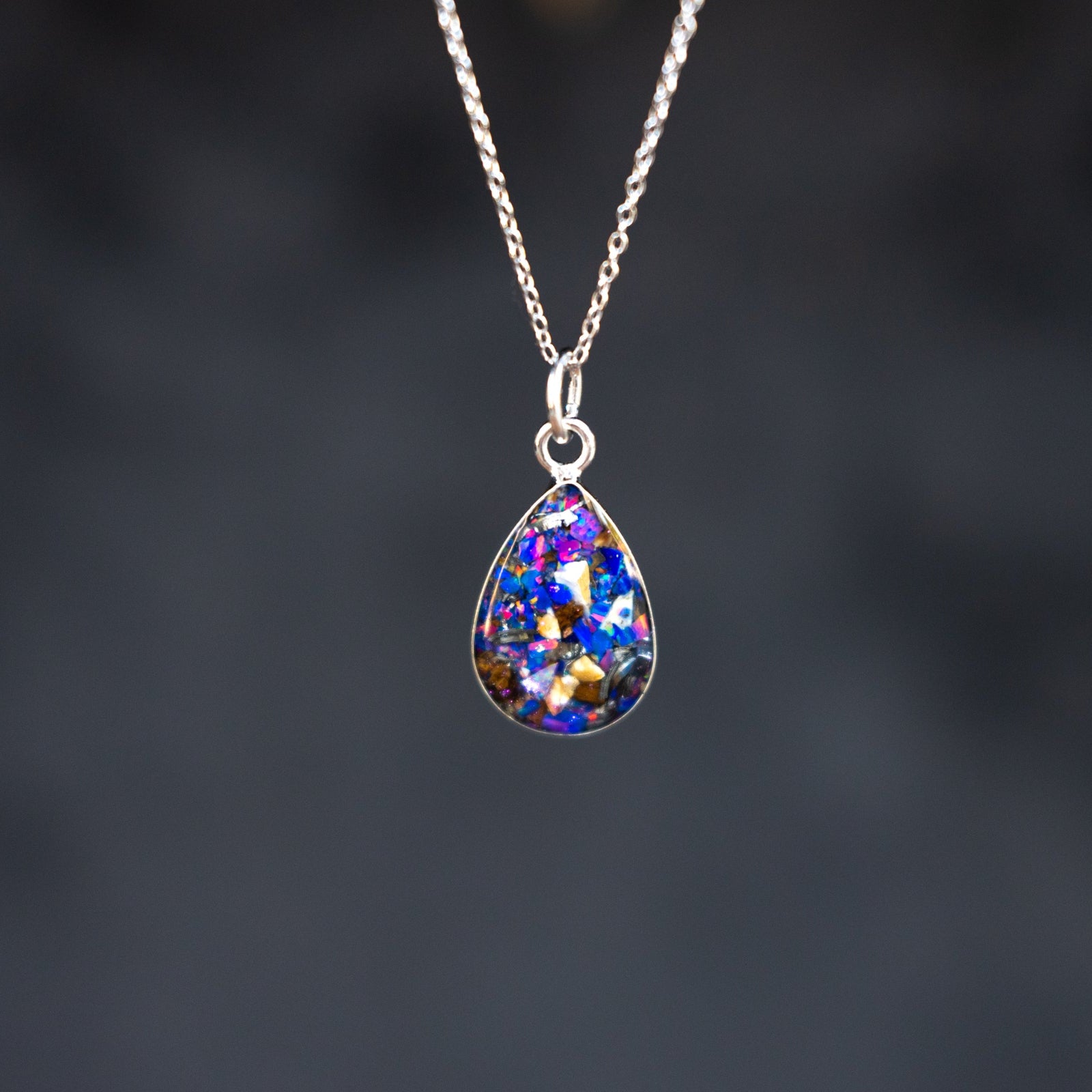 Midnight Raptor Drop authentic silver teardrop pendant necklace with Campo Del Cielo meteorite, real velociraptor fossil bone, and Midnight Opal inlay