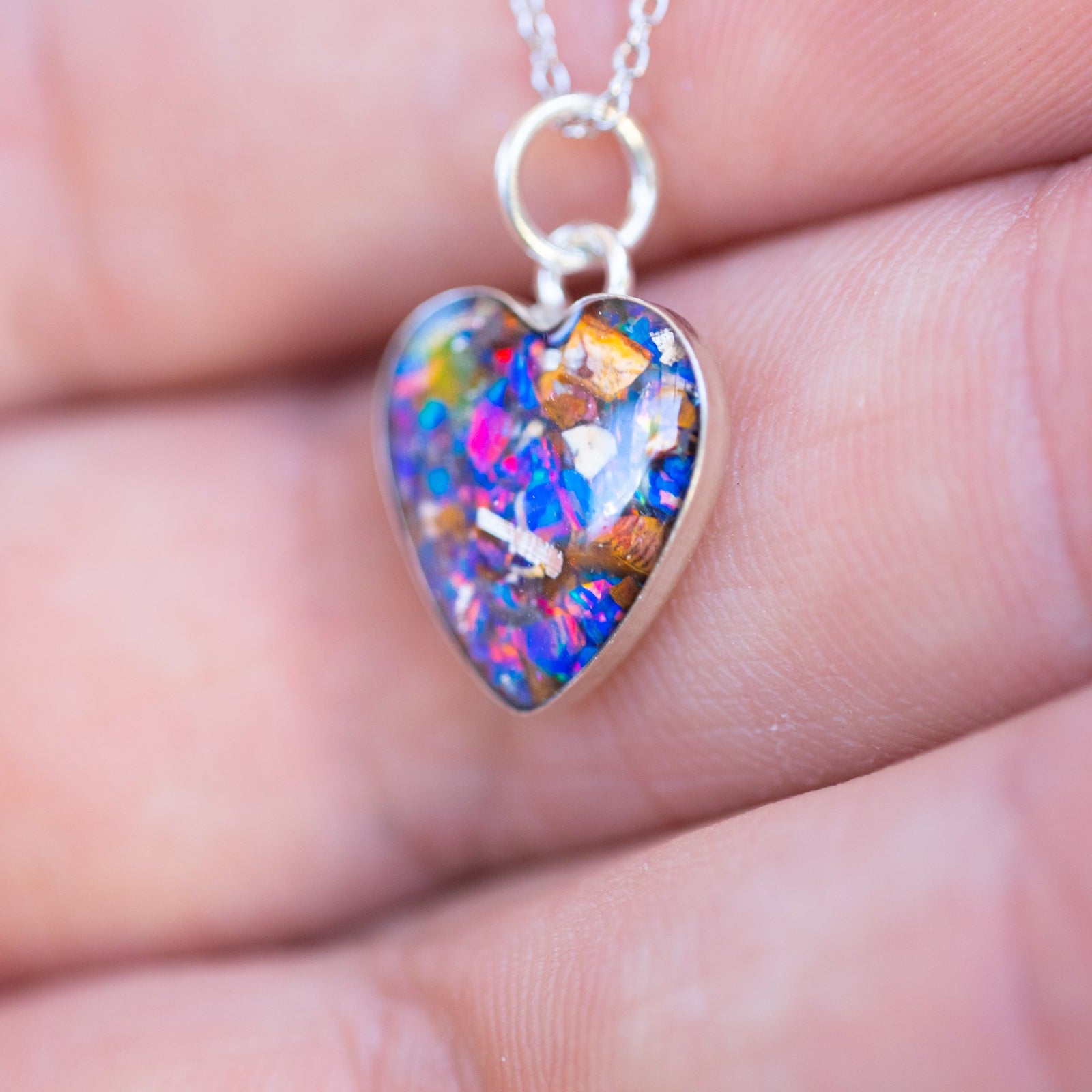 Handcrafted gothic velociraptor fossil heart pendant necklace in sterling silver with Campo Del Cielo meteorite, real dinosaur bone, and Midnight Opal inlay