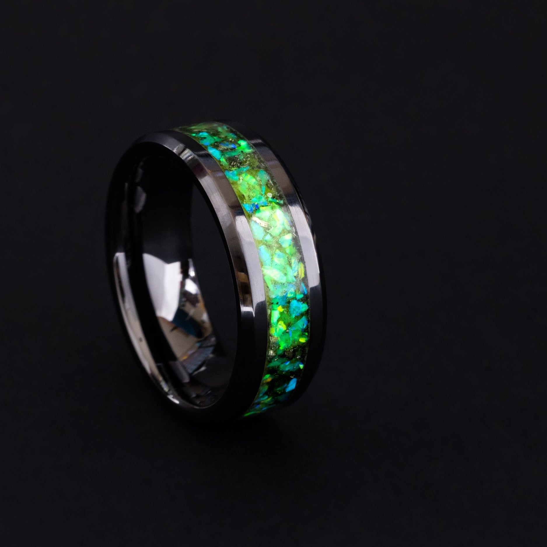 8mm black ceramic wedding band featuring celestial meteorite fragments and lime green glow.