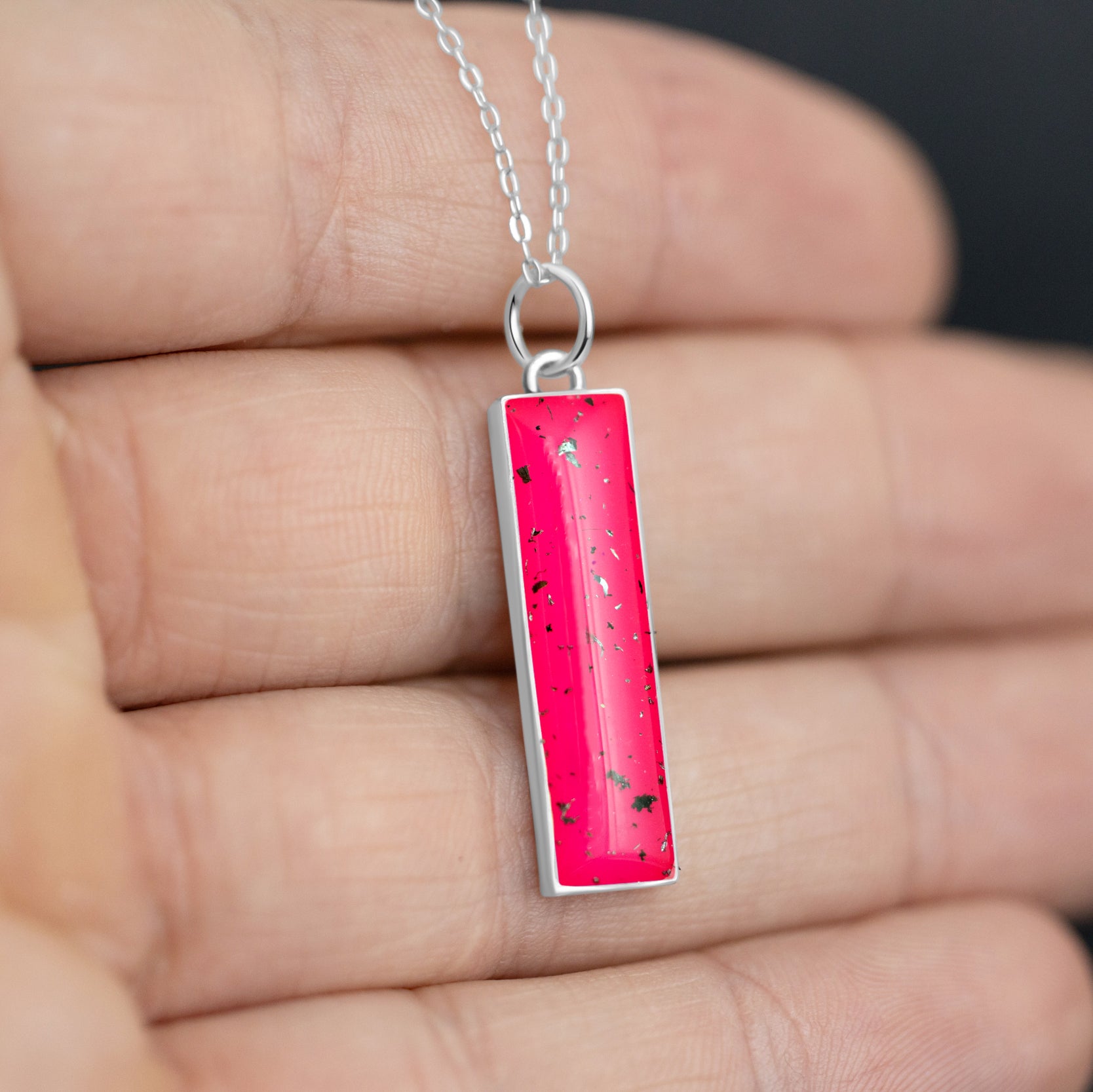 Close-up of the Pink Nova pendant showing authentic Campo Del Cielo meteorite fragments set in pink resin