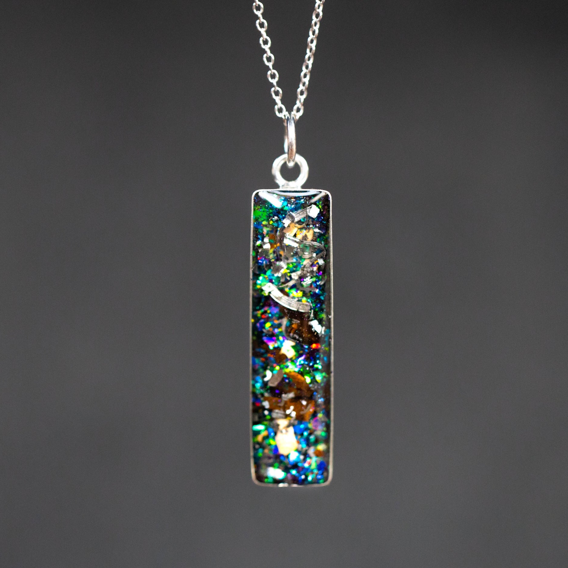 Handcrafted T-Rex and velociraptor fossil bar pendant necklace in sterling silver with Campo Del Cielo meteorite and real dinosaur bone inlay