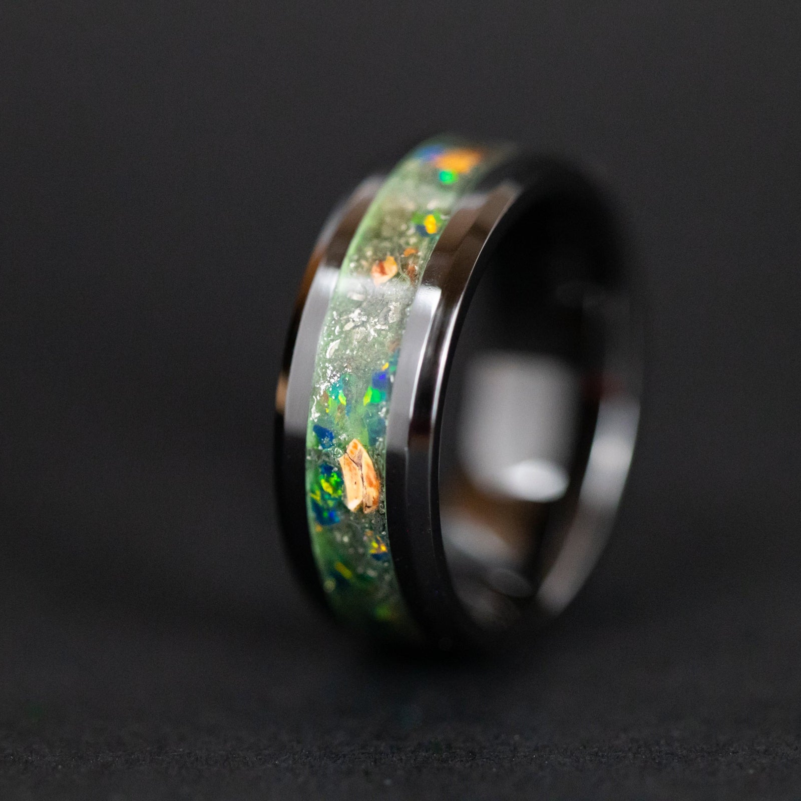 8mm beveled black ceramic ring with authentic Velociraptor bone and Campo del Cielo meteorite in green opal inlay glowing green in the dark