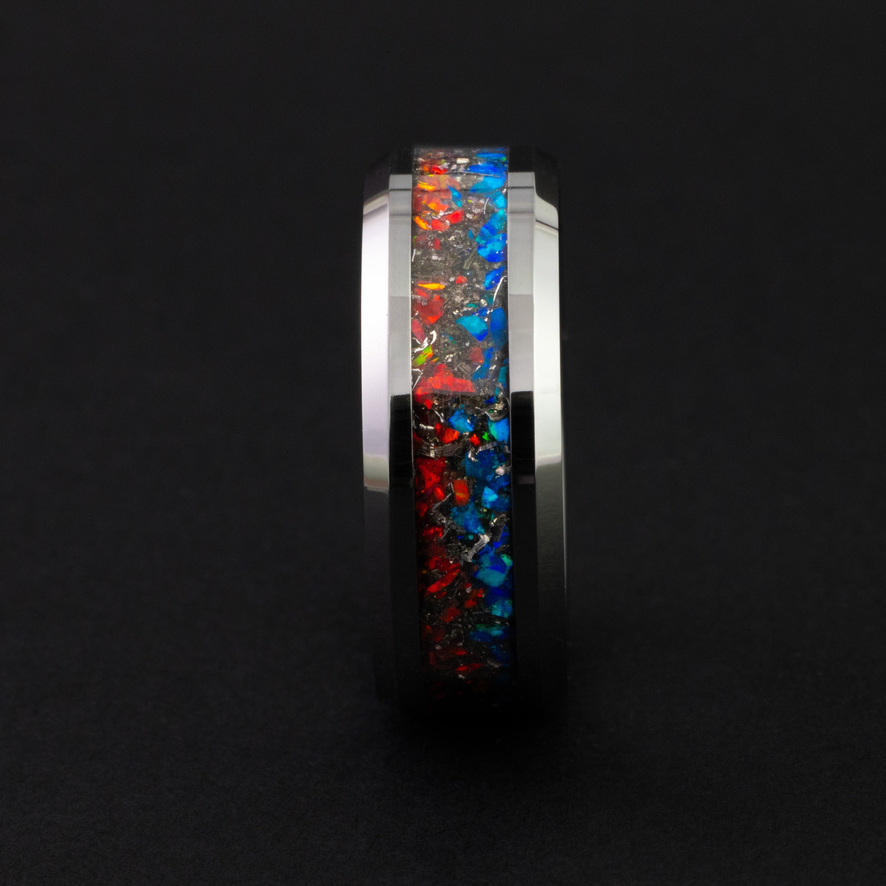 Close up of Campo del Cielo meteorite shavings and fire and ice opals in a silver tungsten ring.