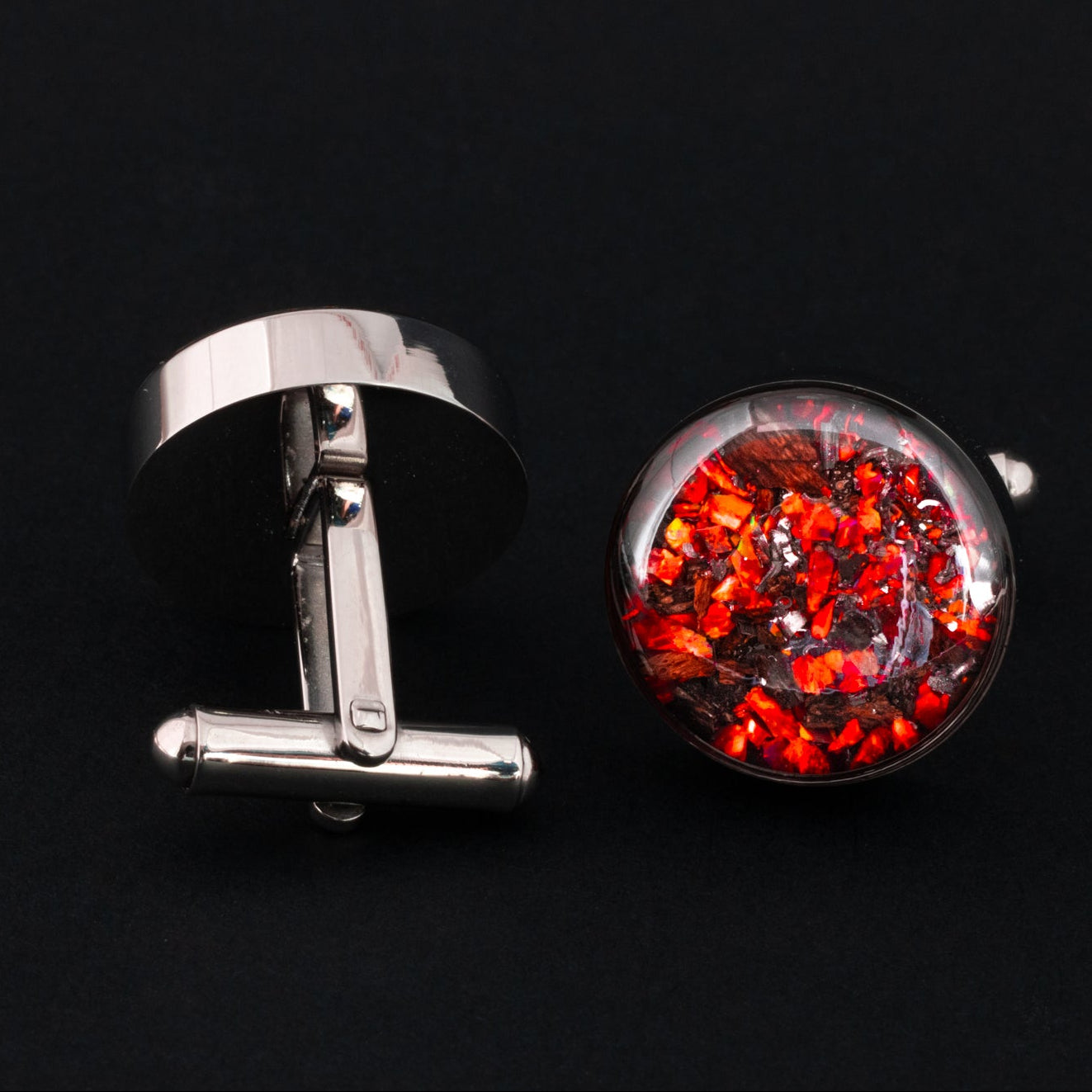 Close-up of the Red TRex Cufflinks showing Campo Del Cielo iron meteorite, real T-Rex bone, and vivid red opal set in polished silver-tone stainless steel