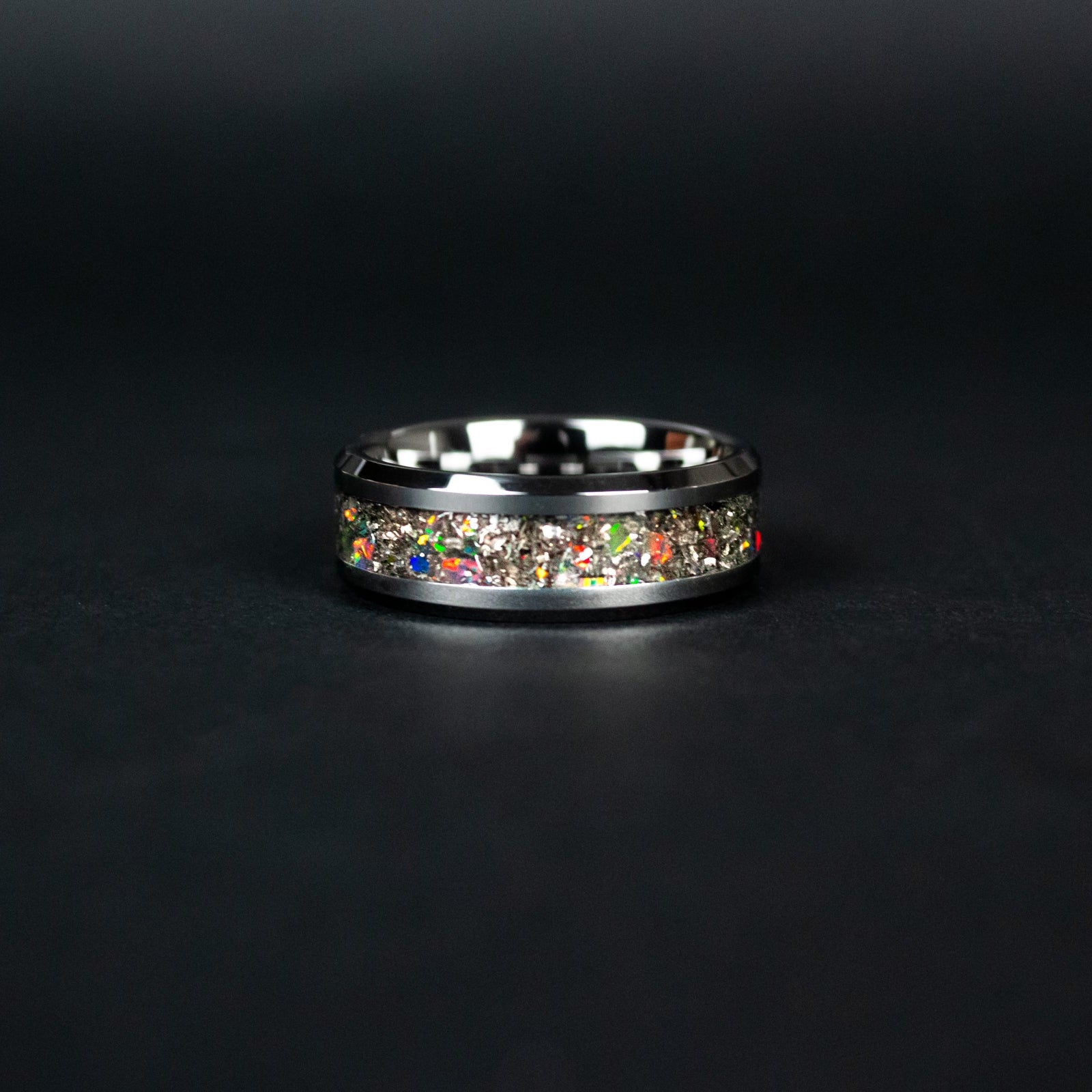 Detail shot of the Shadow Fire ring showing authentic Campo del Cielo meteorite shavings and black fire opal accents revealing flashes of red green and orange fire