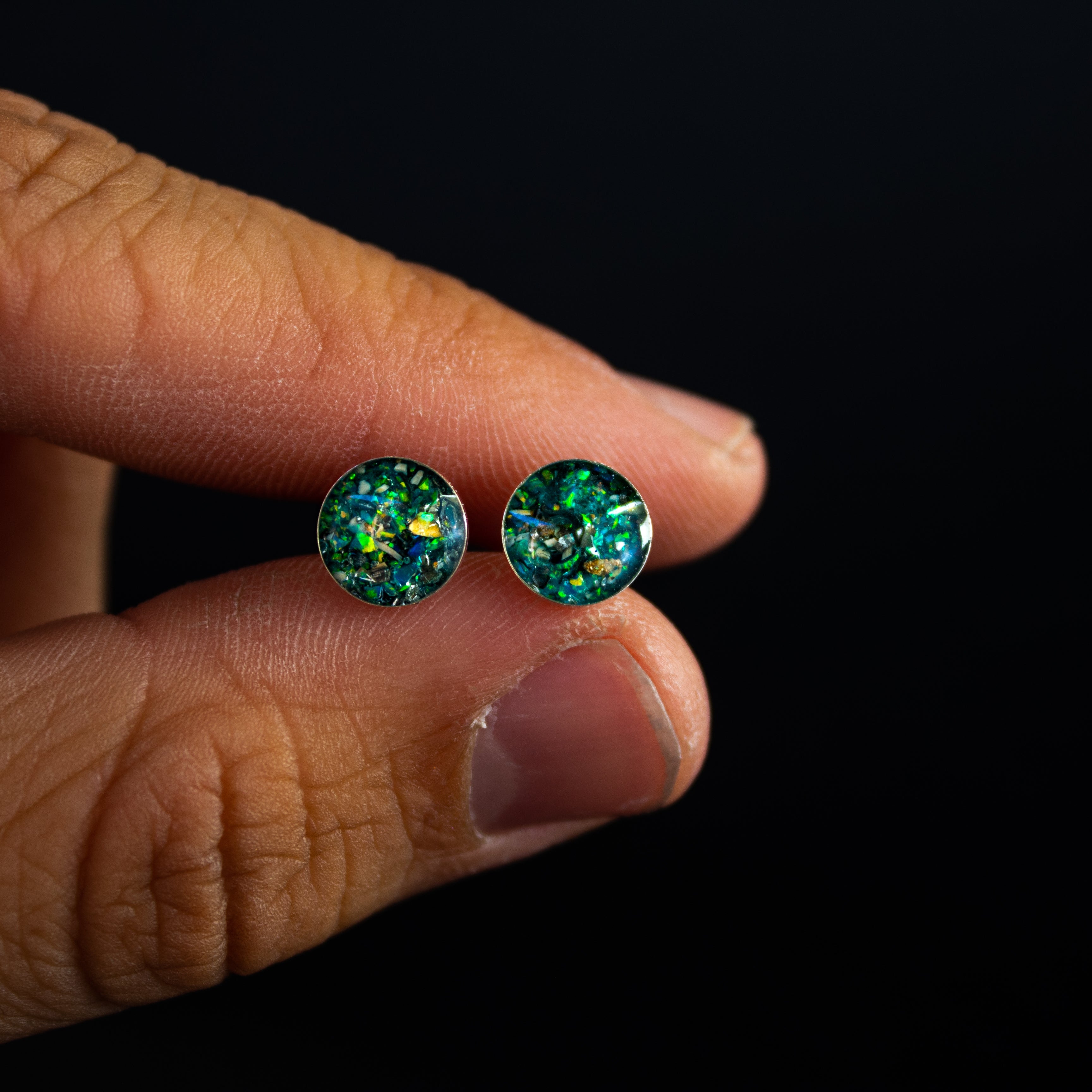 Close-up of the Teal Dinosaur Bone Studs showing Campo Del Cielo iron meteorite, real dinosaur bone, and bright teal blue-green opal in each stud