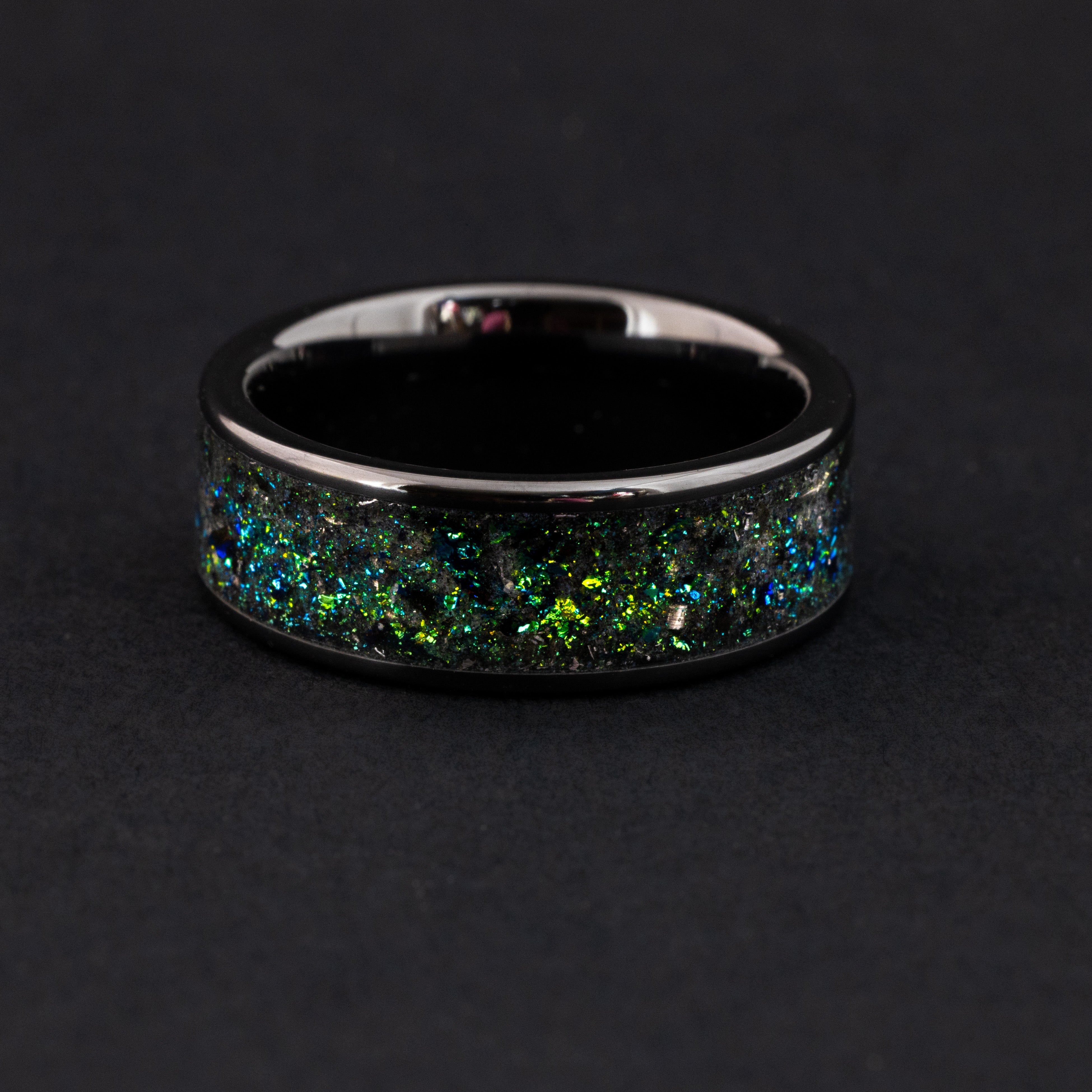 Handcrafted 8mm ceramic wedding band showing the vibrant teal glow in the dark effect