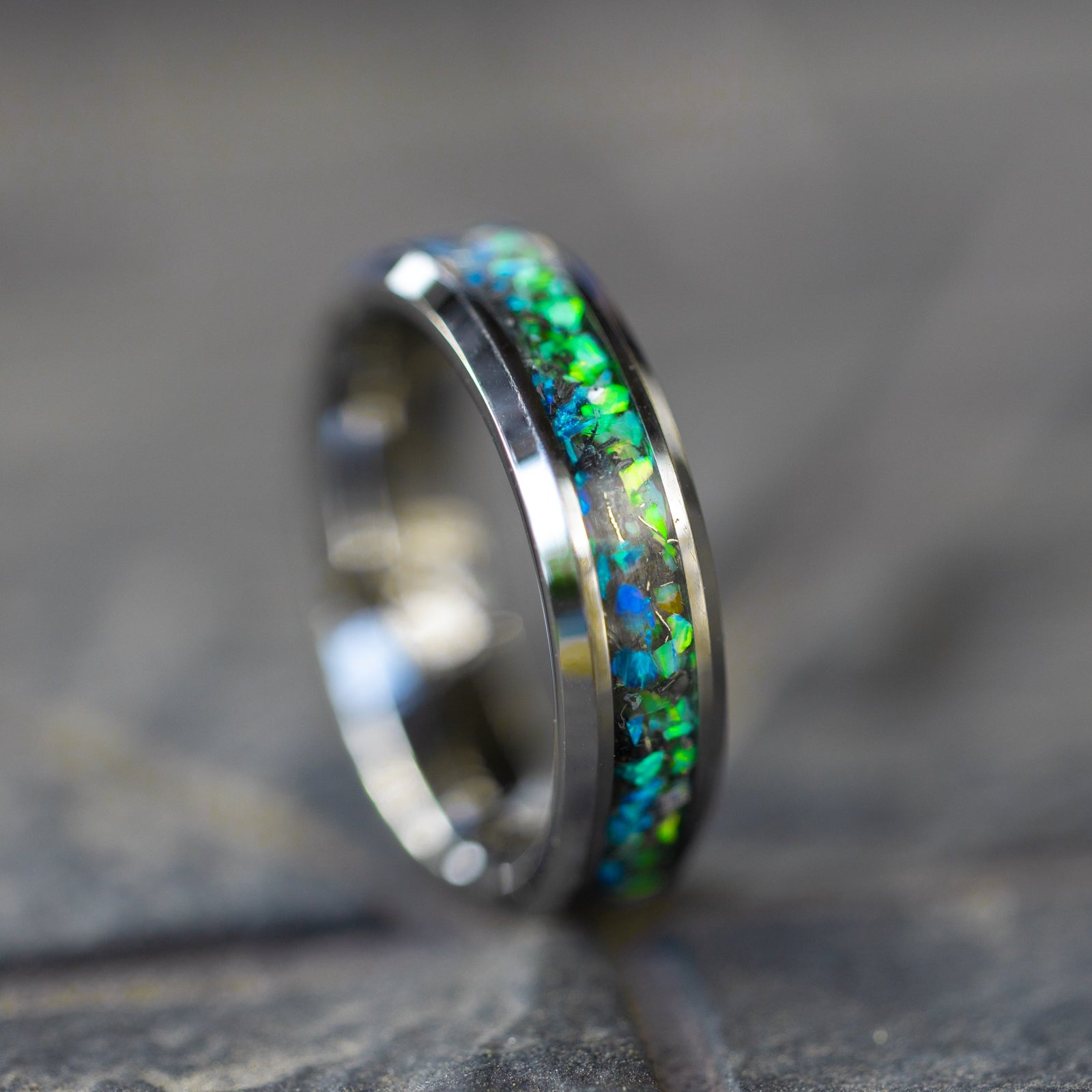 Detail shot of the Tidal Split ring showing authentic Campo del Cielo meteorite shavings bridging the transition between blue and green opal halves