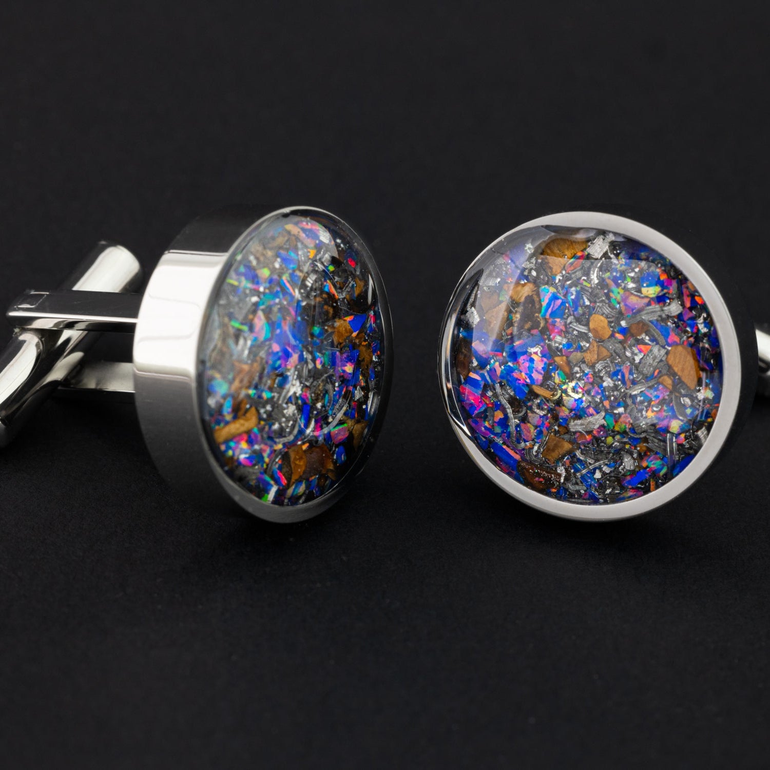Close-up of the TRex Meteorite Cufflinks showing Campo Del Cielo iron meteorite, real T-Rex bone, and proprietary purple blue Midnight Opal set in polished silver-tone stainless steel
