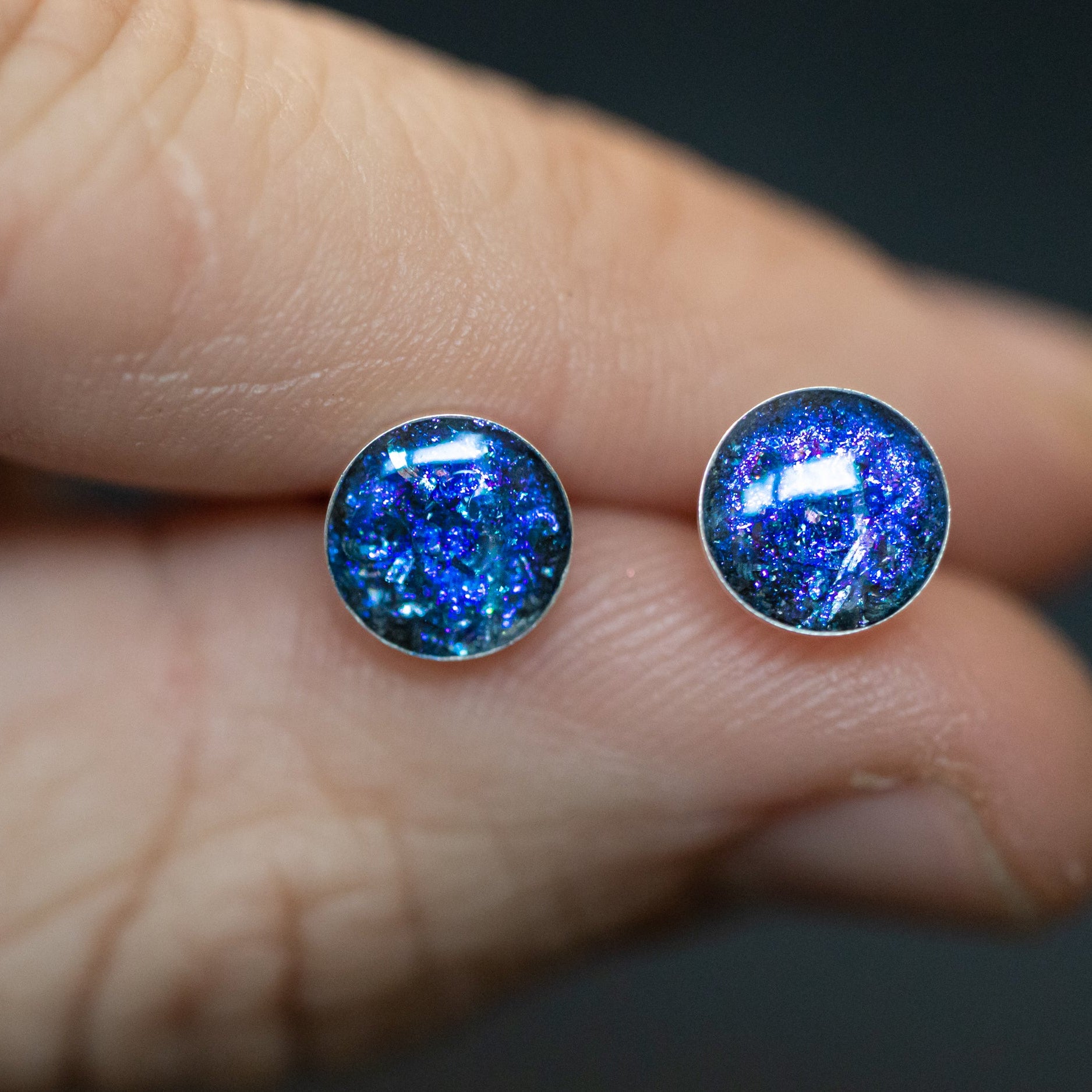 Close-up of the Twilight Studs blue and purple stud earrings showing Campo Del Cielo iron meteorite set in a sparkling twilight sky color field