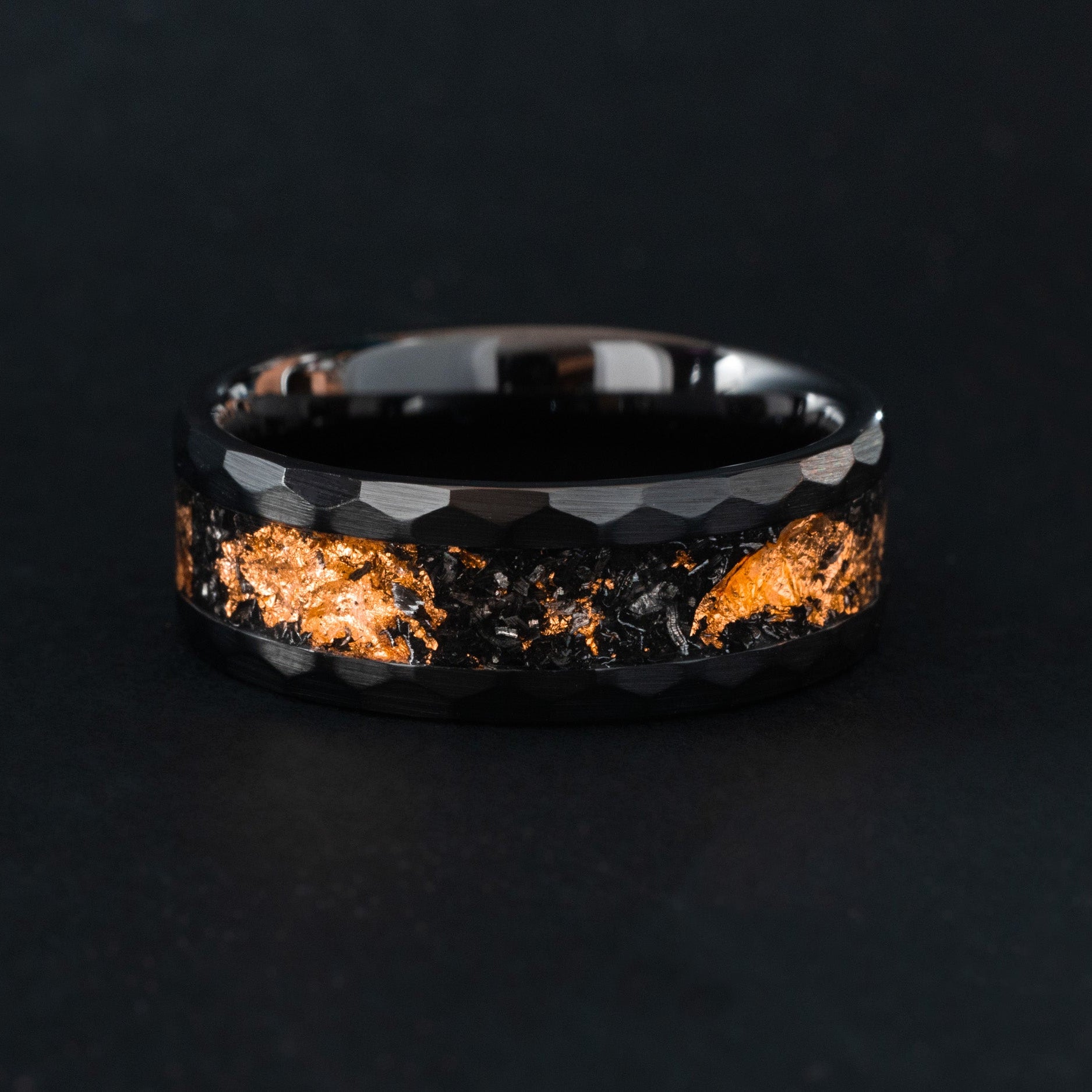 Handcrafted hammered black ceramic wedding band featuring celestial meteorite fragments and copper inlay.