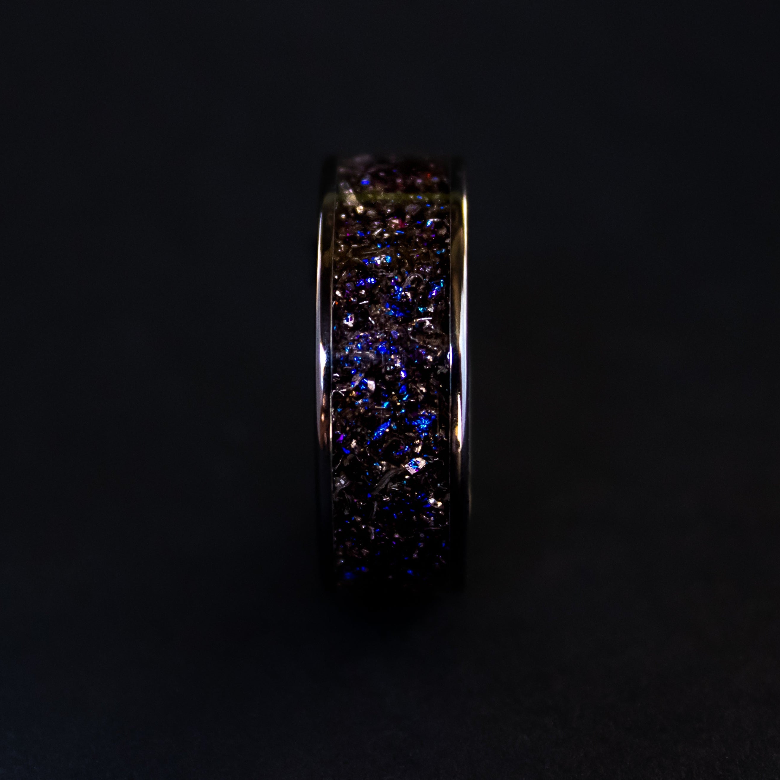 Handcrafted 8mm wide channel black ceramic mens wedding band with authentic Gibeon meteorite in blue and purple galaxy glitter inlay made in California